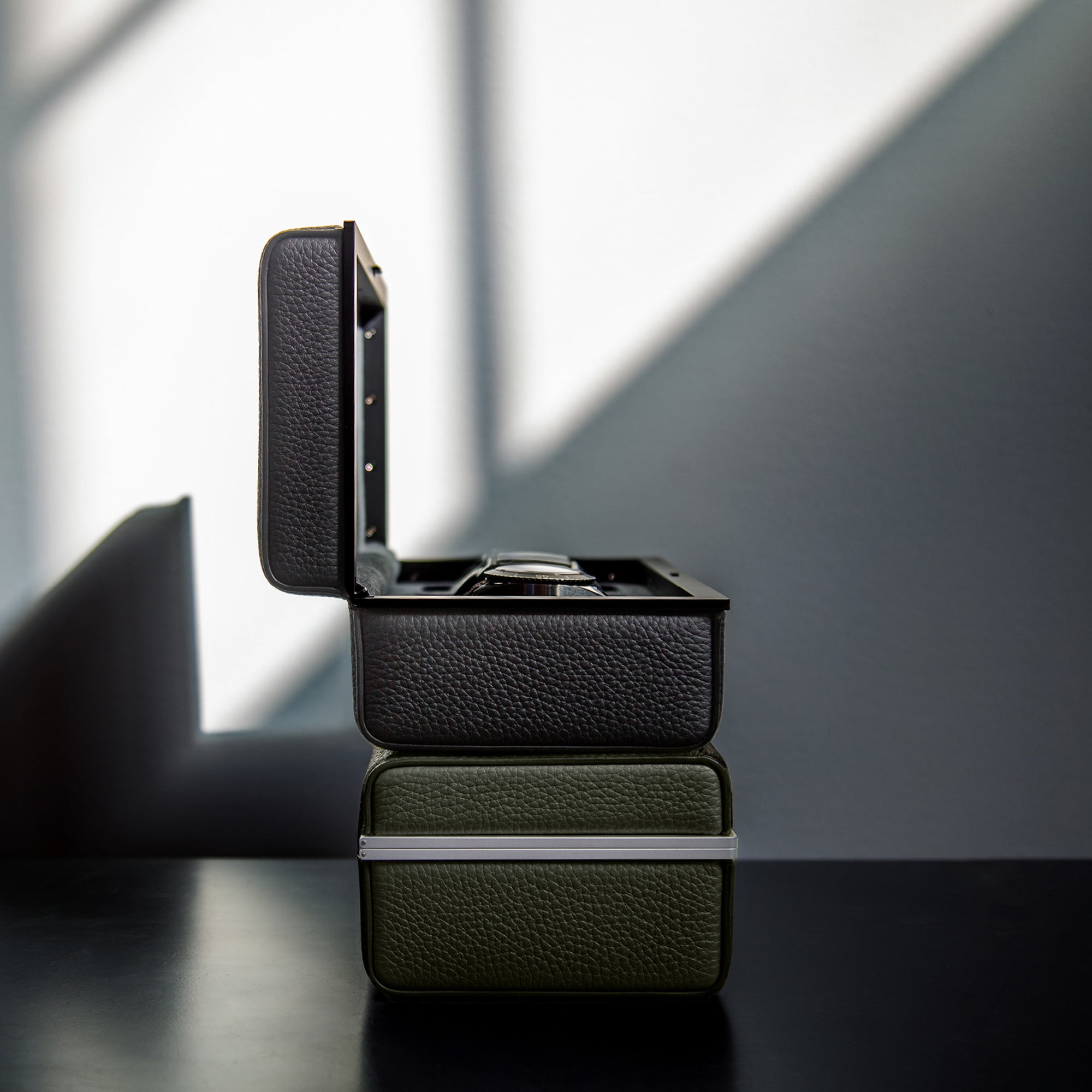lifestyle photo of 2 eaton 3 watch cases in black and khaki, Charles-Simon_Eaton-3_watch-case_all-black_16