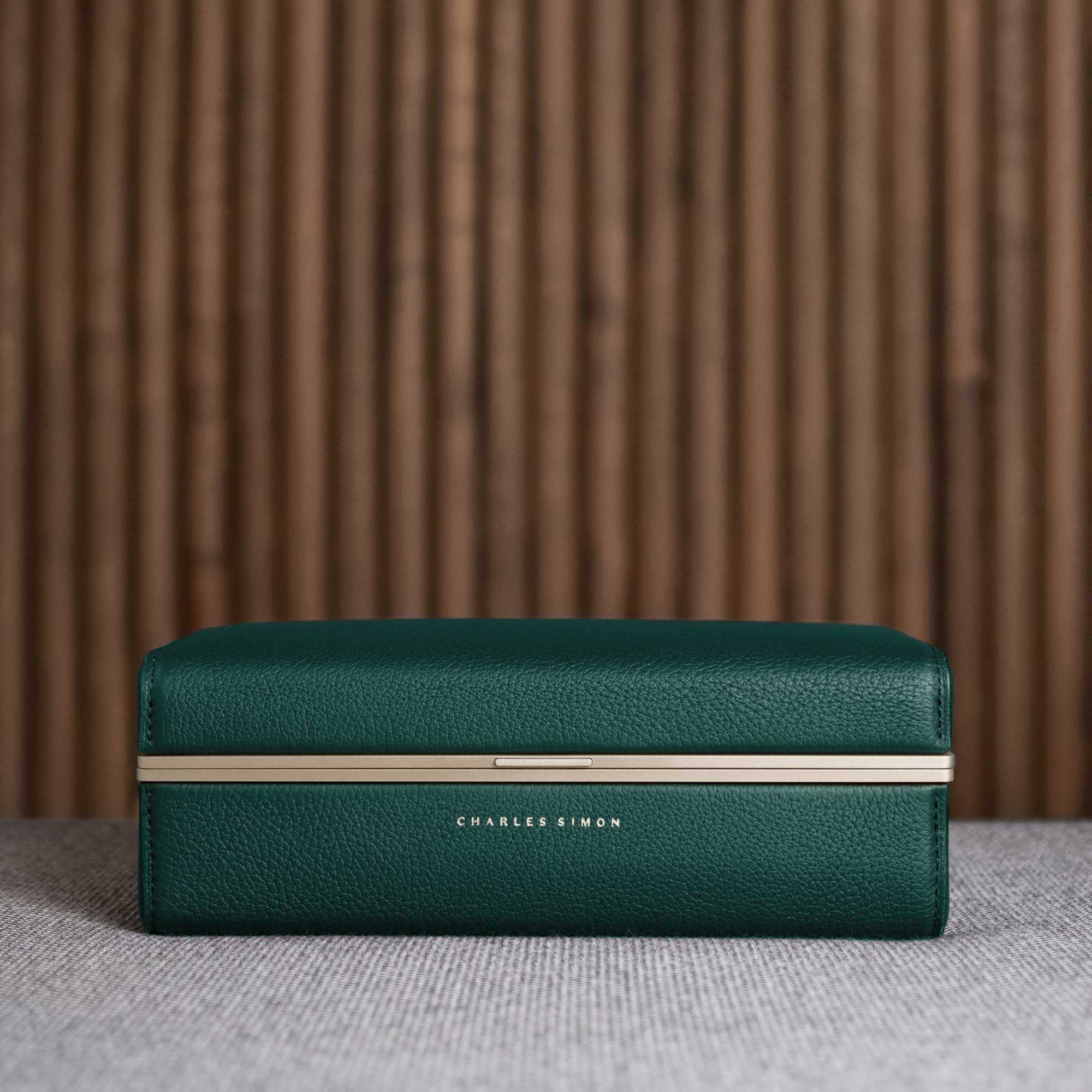 Closed Eaton 3 Watch case in emerald leather featuring golden accents. Handmade in Canada.