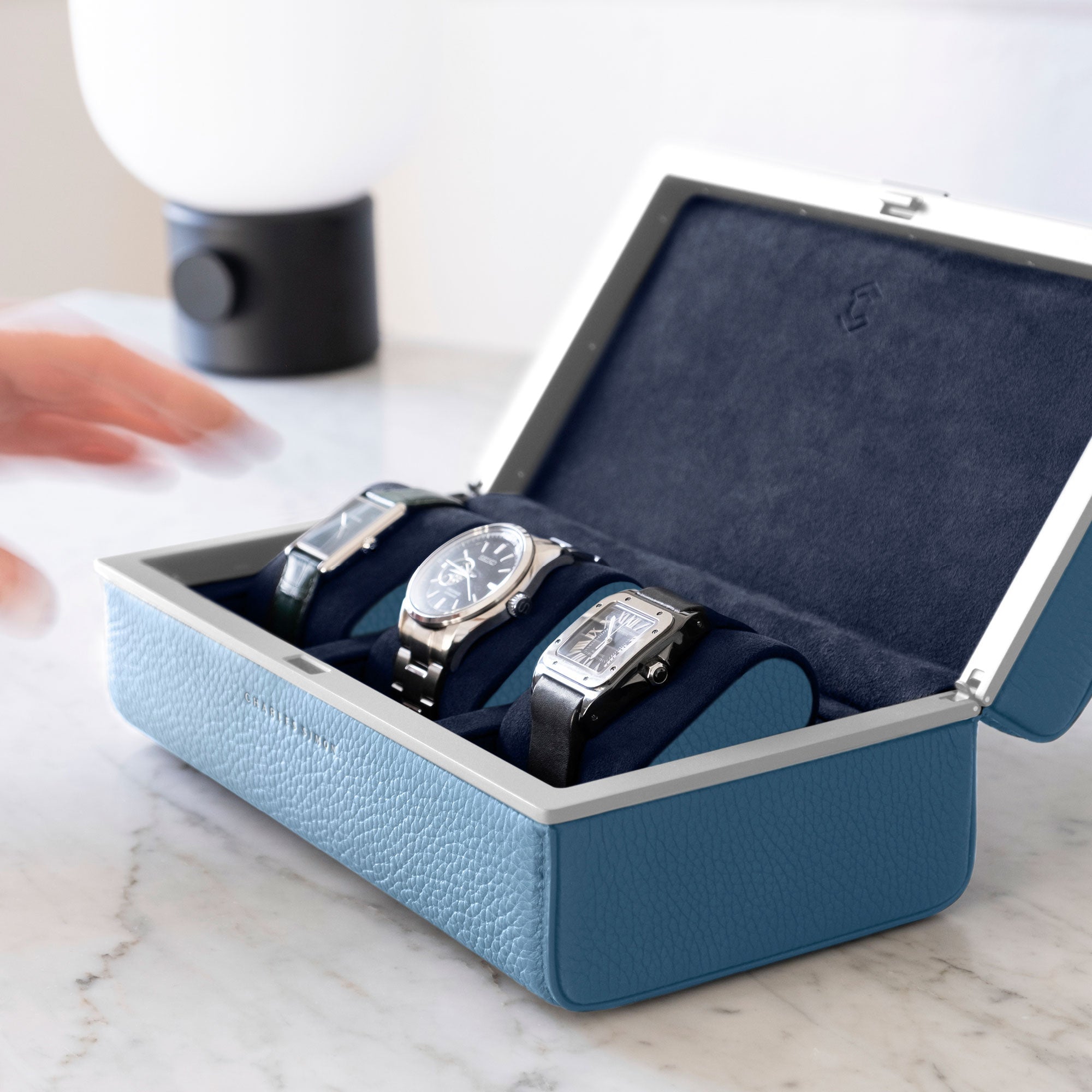 Lifestyle shot of Eaton 3 watch case for 3 watches holding a watch collection of 3 luxury timepieces