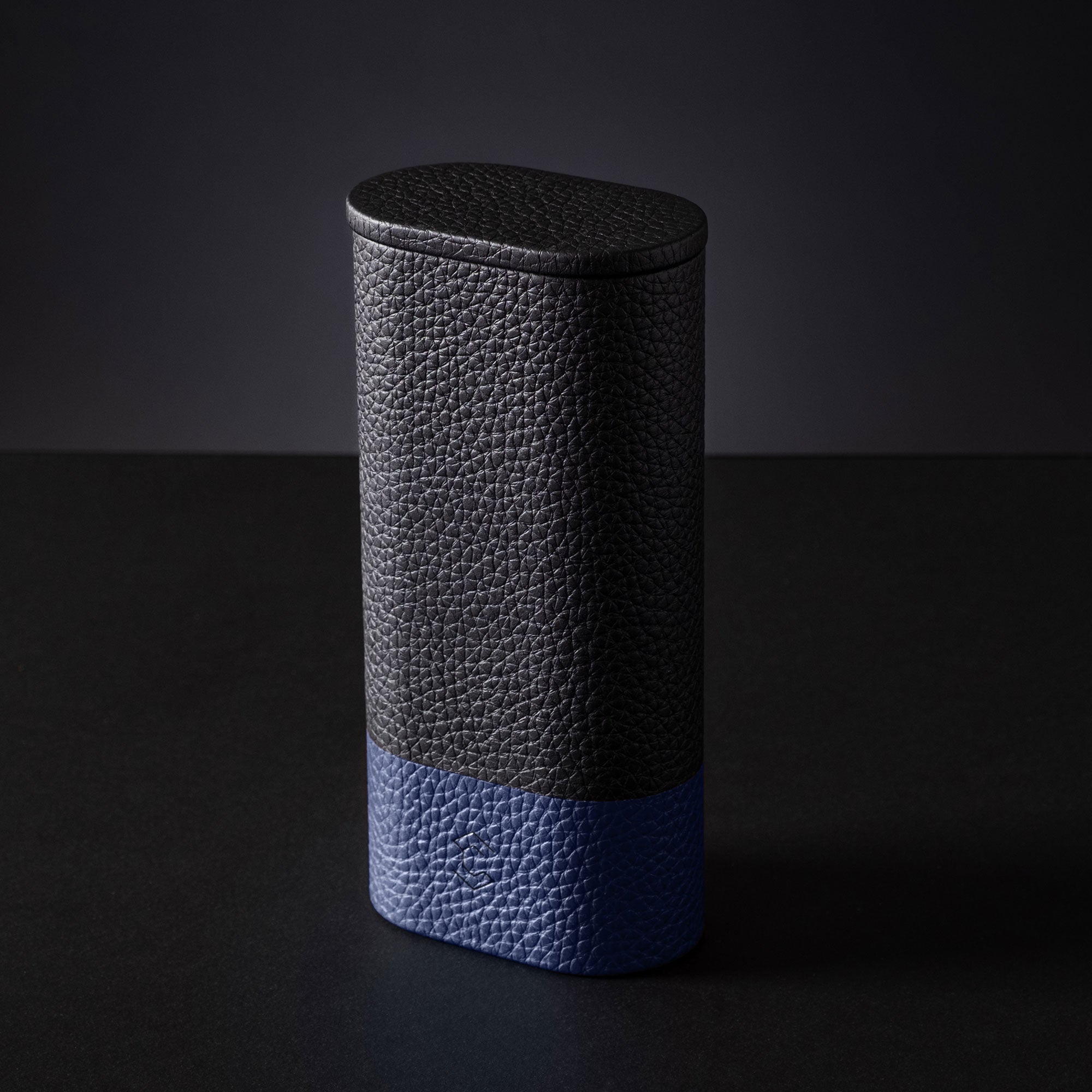 Leather watch roll for travel, compact design for secure storage, in black and blue.