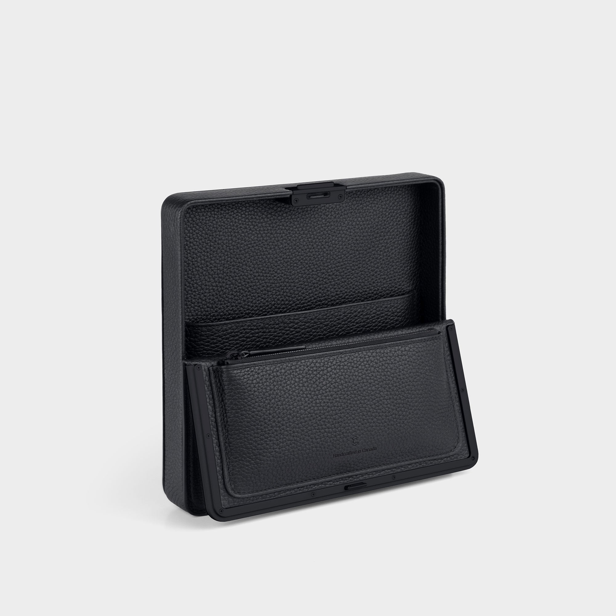 Product photo of the open all black Fraser Travel wallet showing the convenient interior zipped pouch and compartments. 