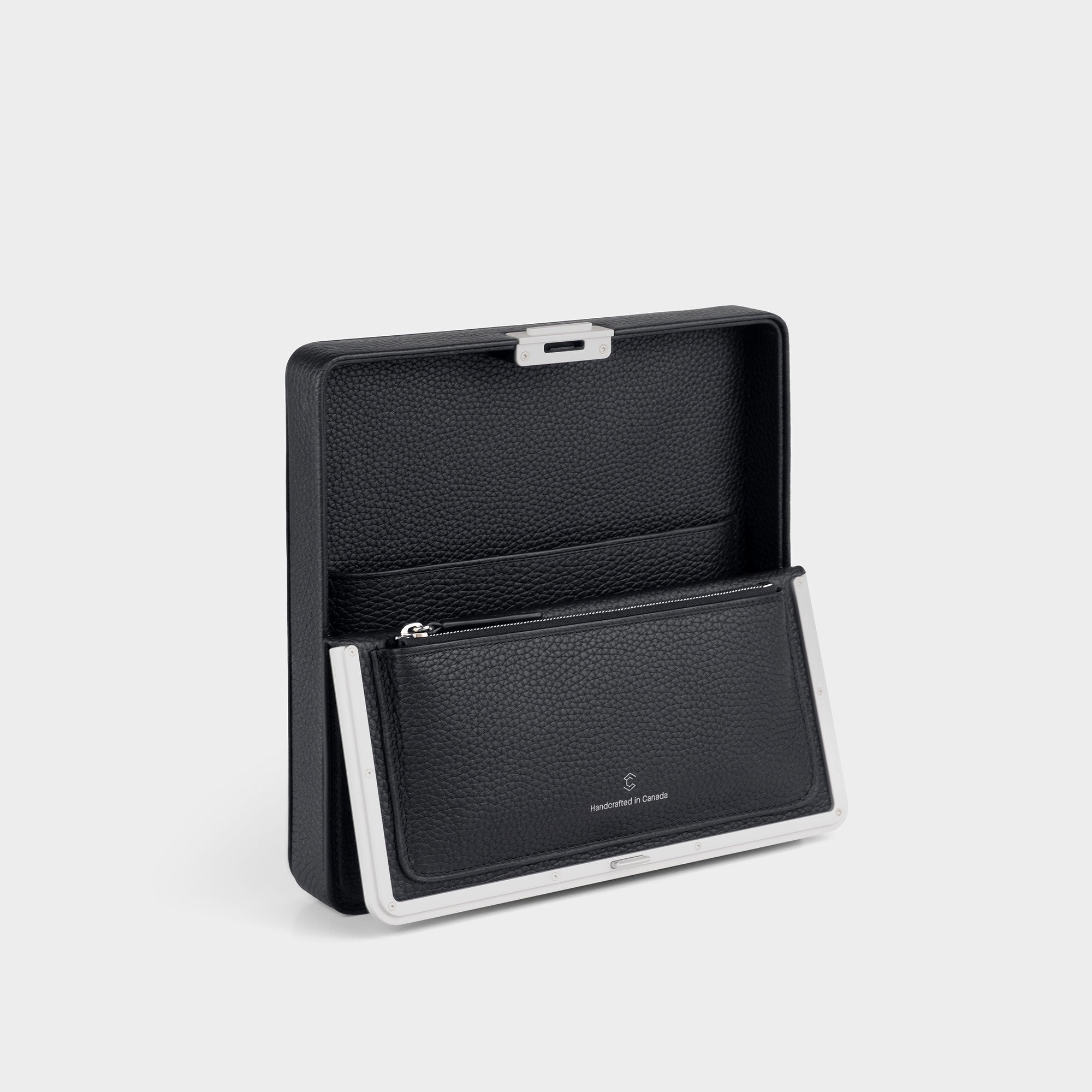 Charles Simon Fraser wallet in black leather open view, showcasing the zipped pouch and convenient compartment for travel belongings. 