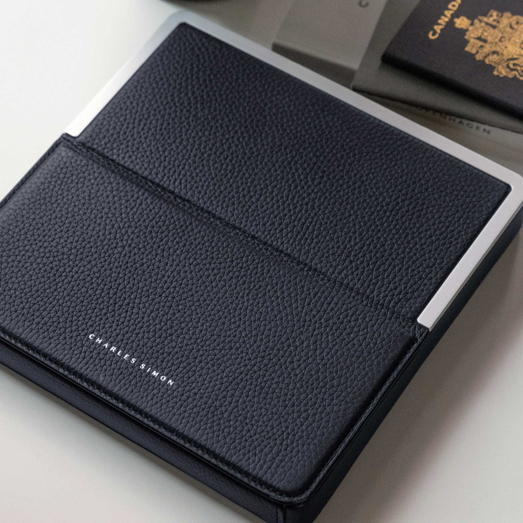 Lifestyle photo of the Fraser Travel wallet in marine leather by Charles Simon. Your elegant and functional travel companion
