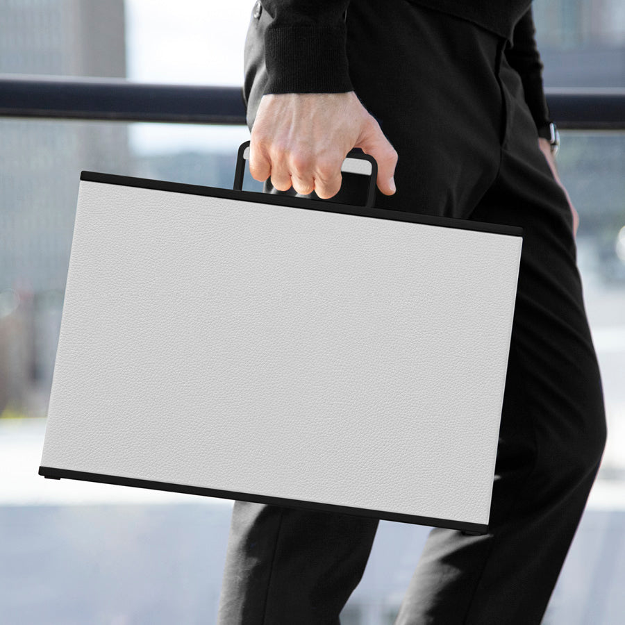 Modern business man carrying his white leather and black casing Mackenzie Briefcase to work