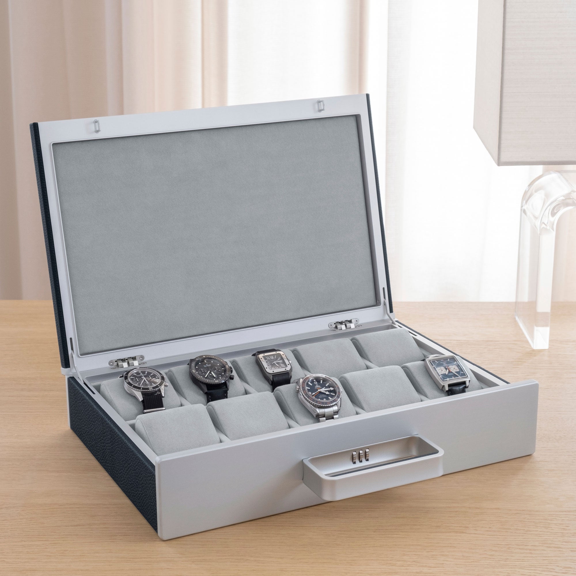 Lifestyle photo of open Mackenzie 10 Watch briefcase showcasing a luxury watch collection of up to 10 watches
