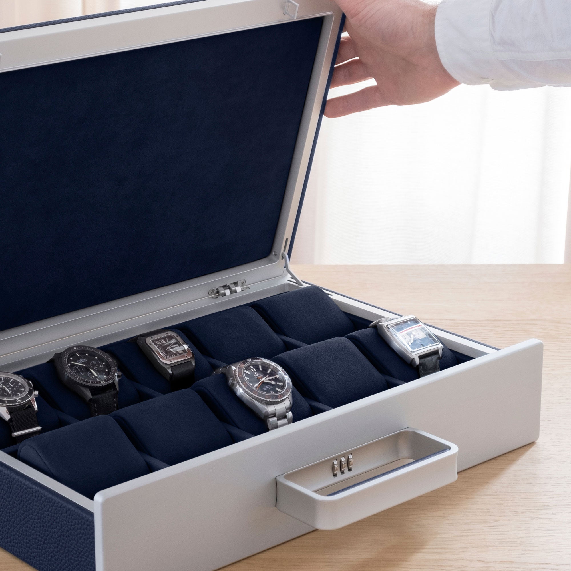Lifestyle shot of Mackenzie Watch briefcase 10 filled with luxury watches including Blancpain, Tag Heuer and Jaeger-LeCoultre placed on deep blue removable watch cushions