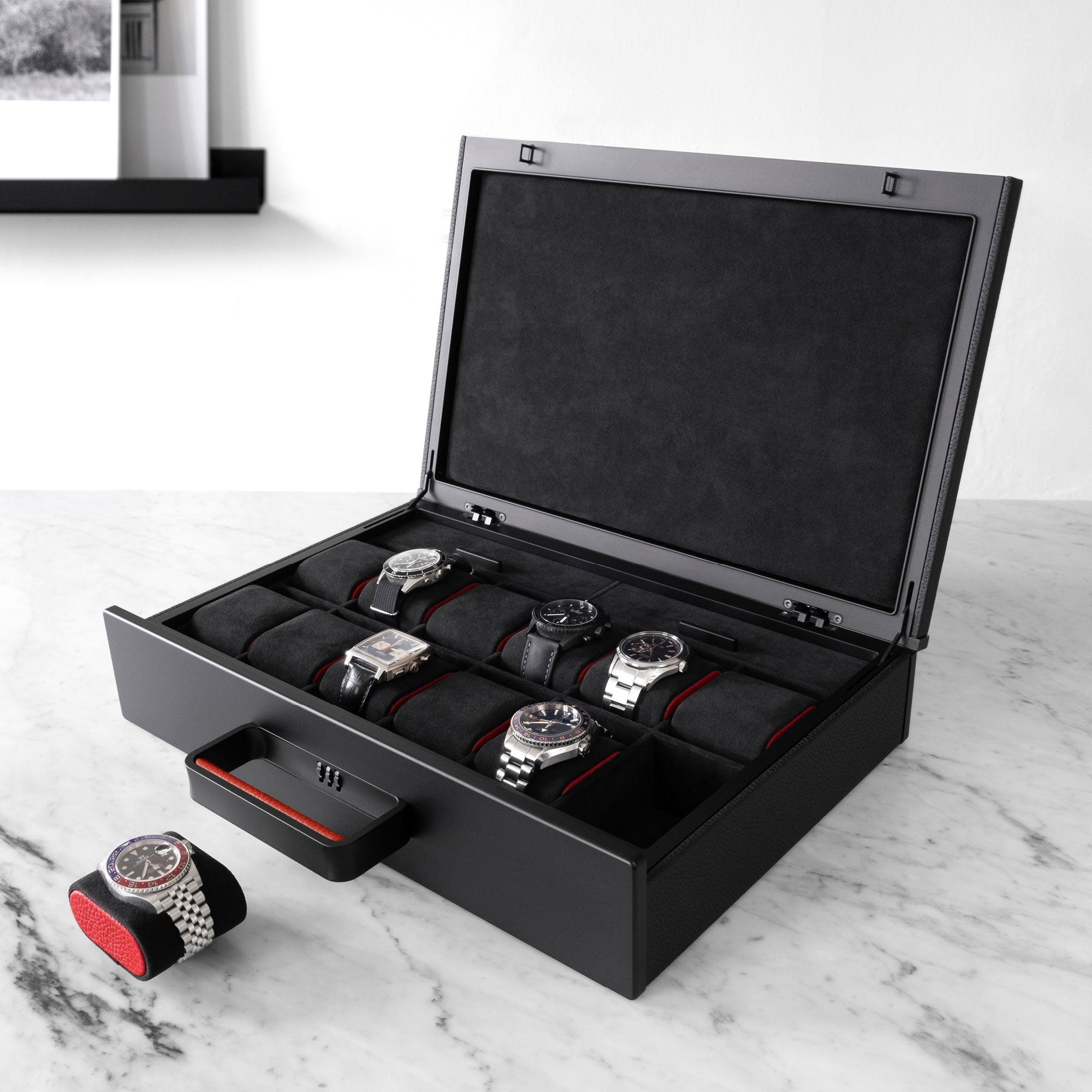 Designer Watch briefcase for 12 watches in black leather with contrasting red leather accents, carbon fiber, black anodized aluminum and black Alcantara interior with luxury watches including Tag Heuer, Rolex, Blancpain and Omega