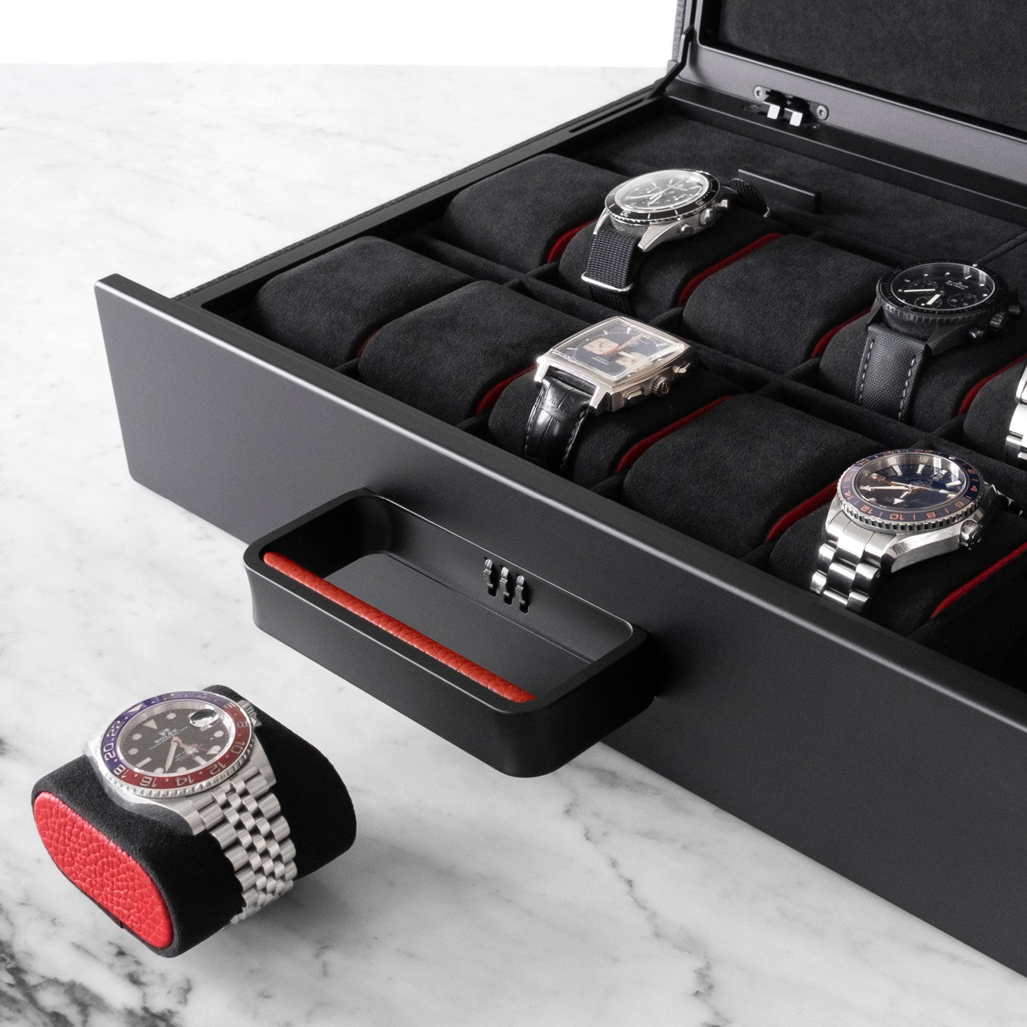 Detail shot showing removable black Alcantara watch cushion with red leather side accents with Rolex GMT Master Pepsi placed on removable cushion 