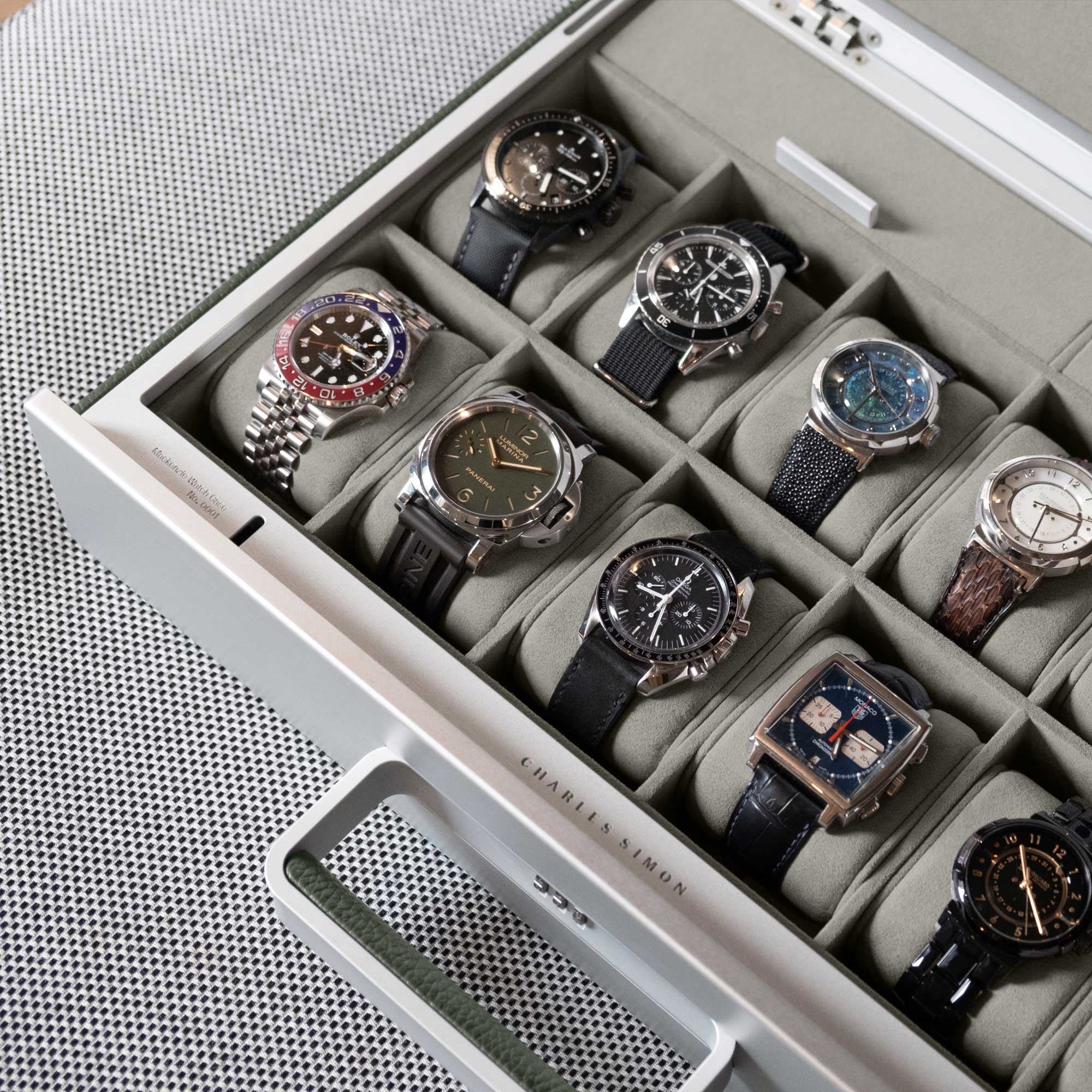 Detail shot of luxury watch collection displayed in khaki leather Mackenzie 12 Watch briefcase