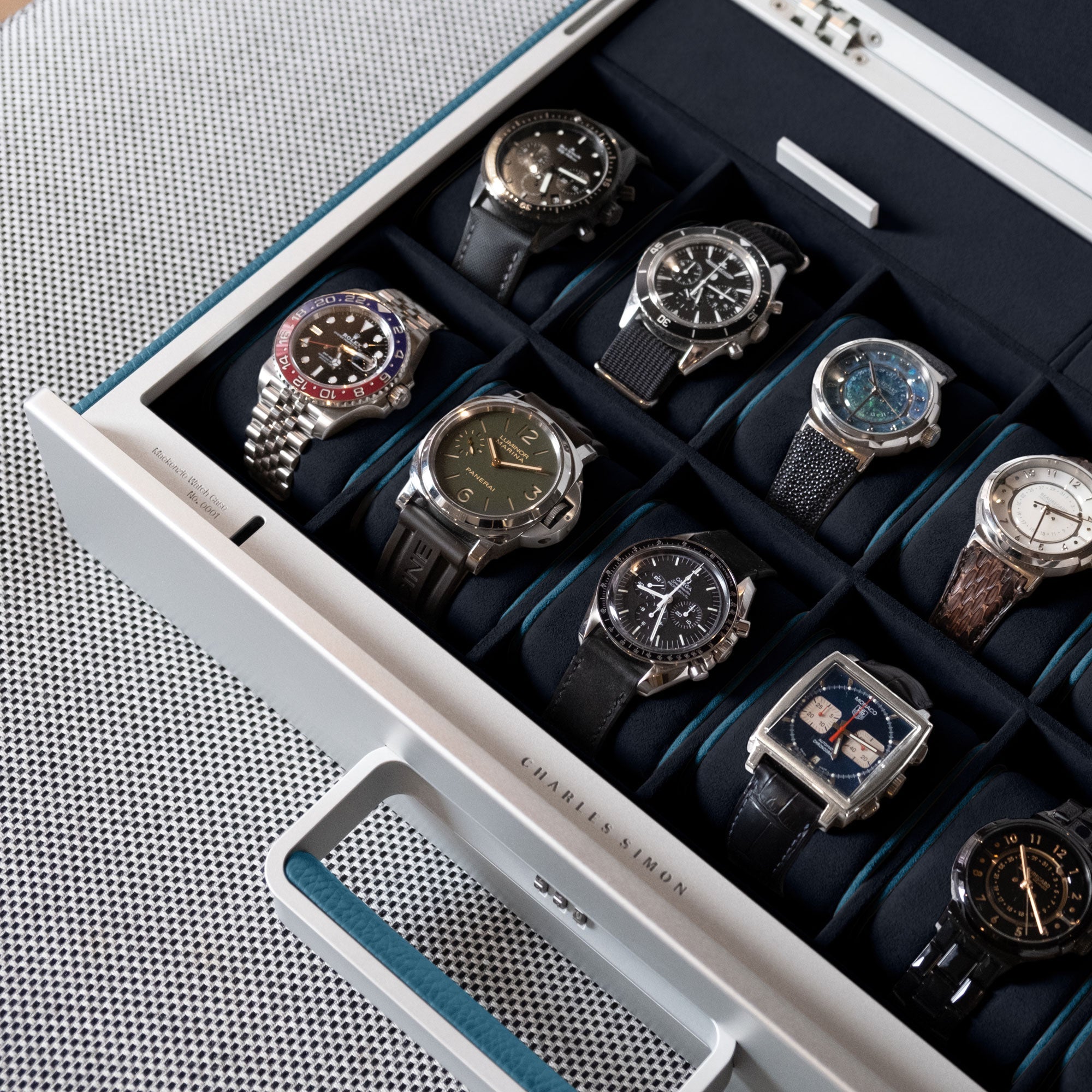 Lifestyle shot of Mackenzie 12 watch briefcase filled with luxury watches including Rolex, Panerai and Omega