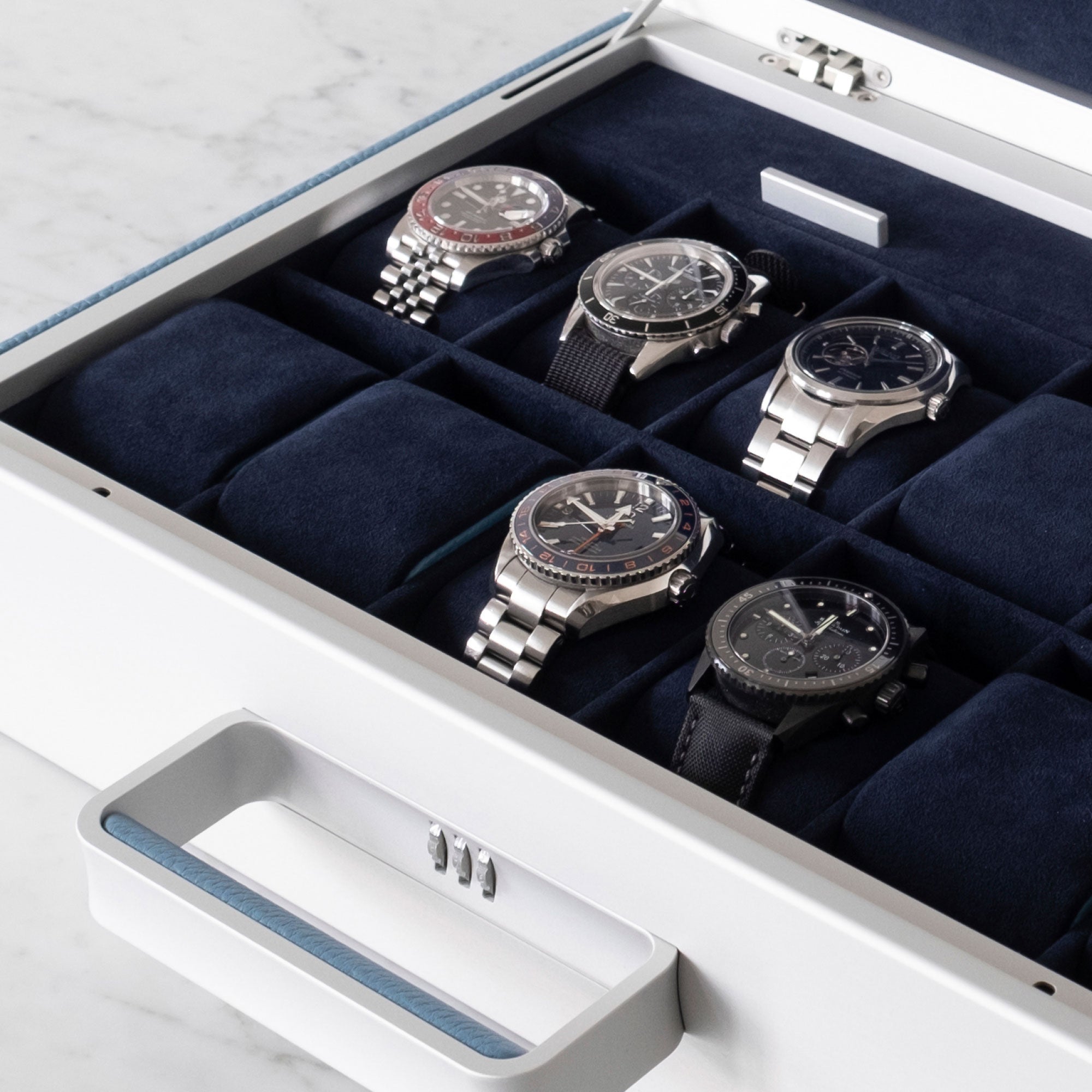 Lifestyle shot of Mackenzie 12 watch briefcase filled with luxury watches including Rolex, Blancpain and Omega