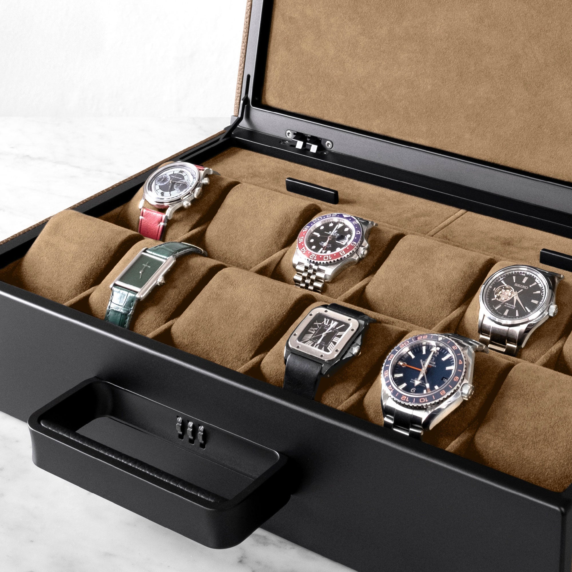 Lifestyle shot of Mackenzie Watch briefcase filled with luxury watches including Rolex, Cartier and Omega