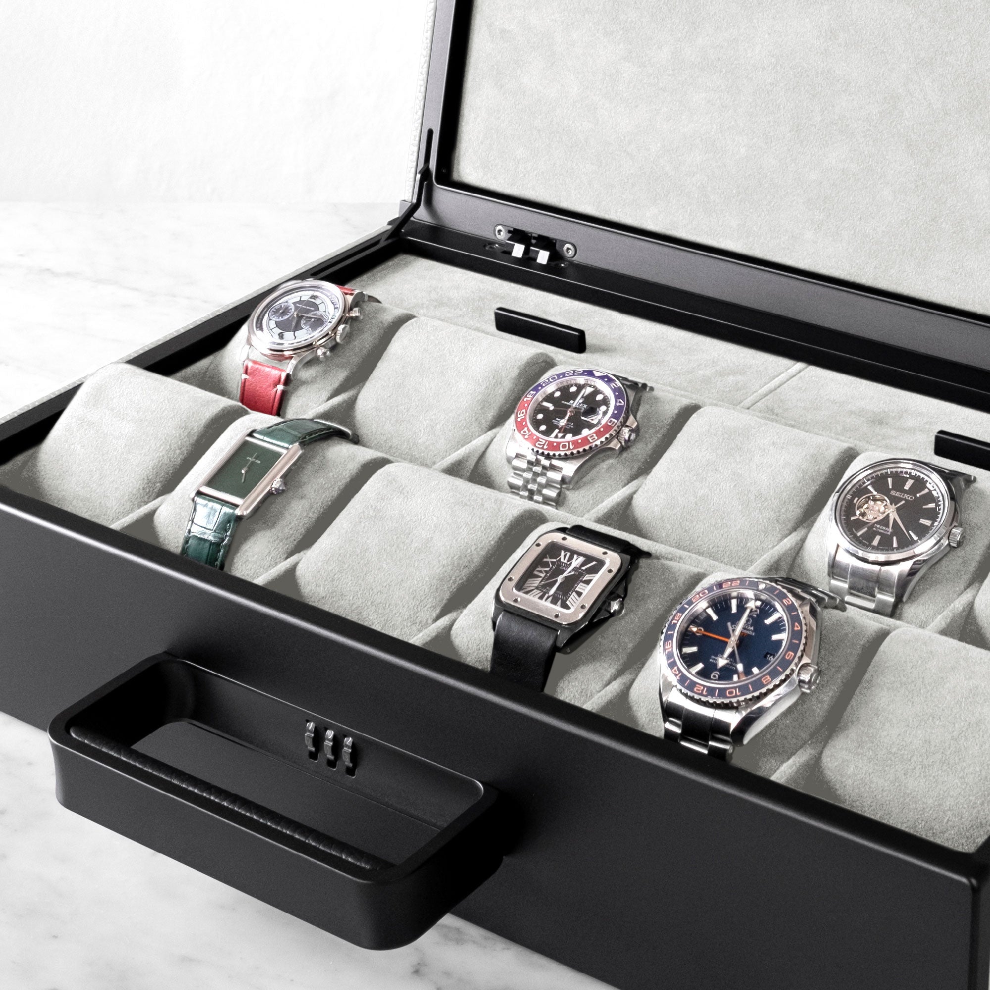 Lifestyle shot of Mackenzie Watch briefcase 12 filled with luxury watches including Rolex, Omega and Cartier