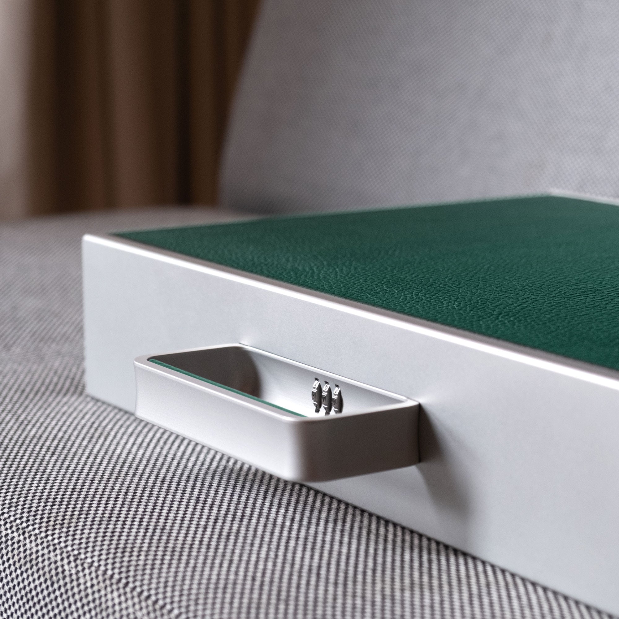 Detail shot of emerald Mackenzie watch briefcase anodized aluminum handle with lock with protective code