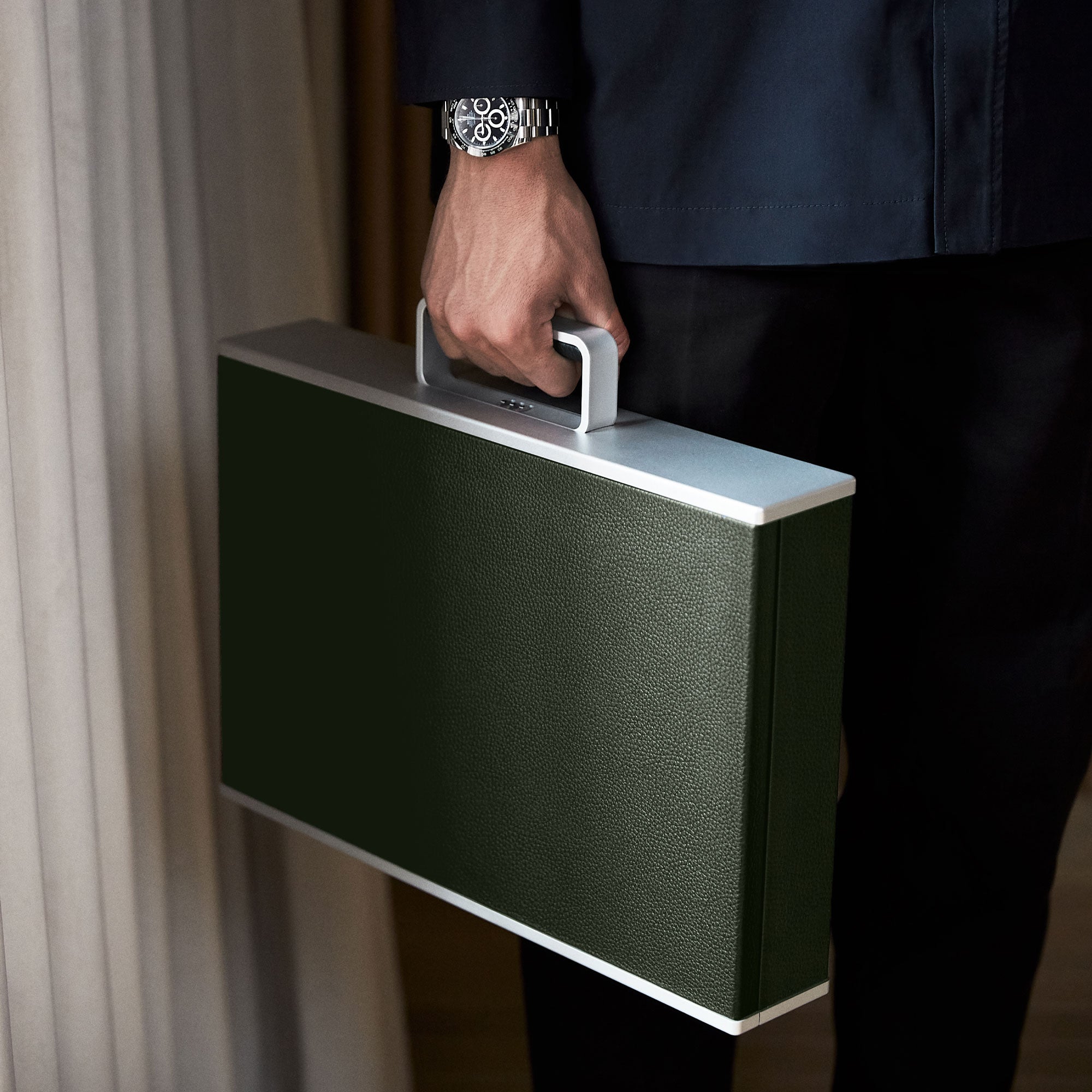 Stylish man holding his Mackenzie luxury briefcase in kaki leather