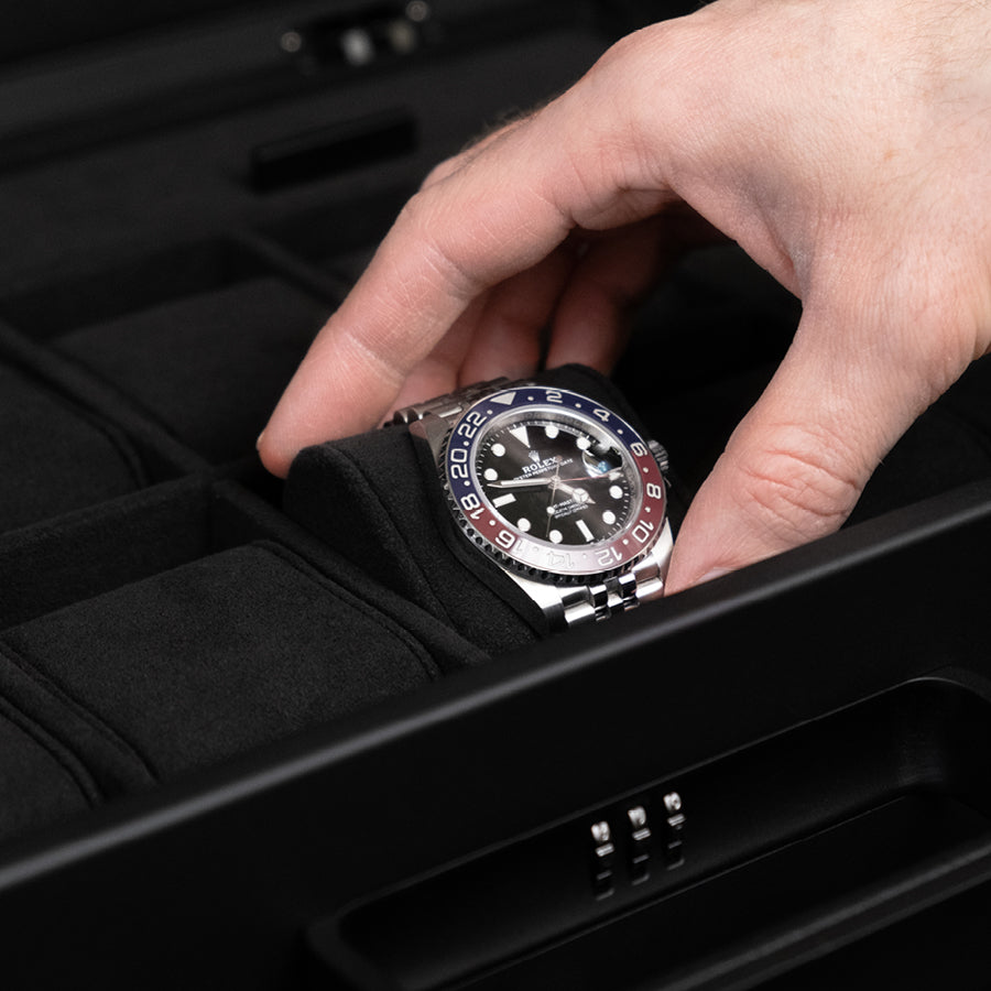 Luxury men's watch placed on soft removable Alcantara cushion from the all black Mackenzie 10 watch case. Features sleek aluminum handle and lock with customizable code