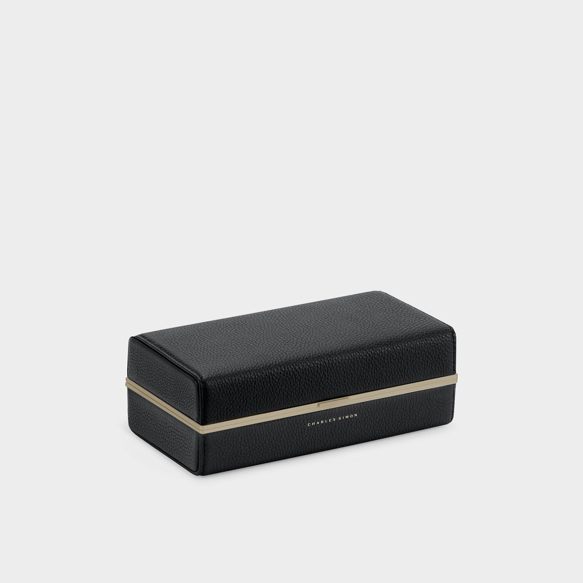 Product photo of closed black and gold luxury toiletry bag by Charles Simon