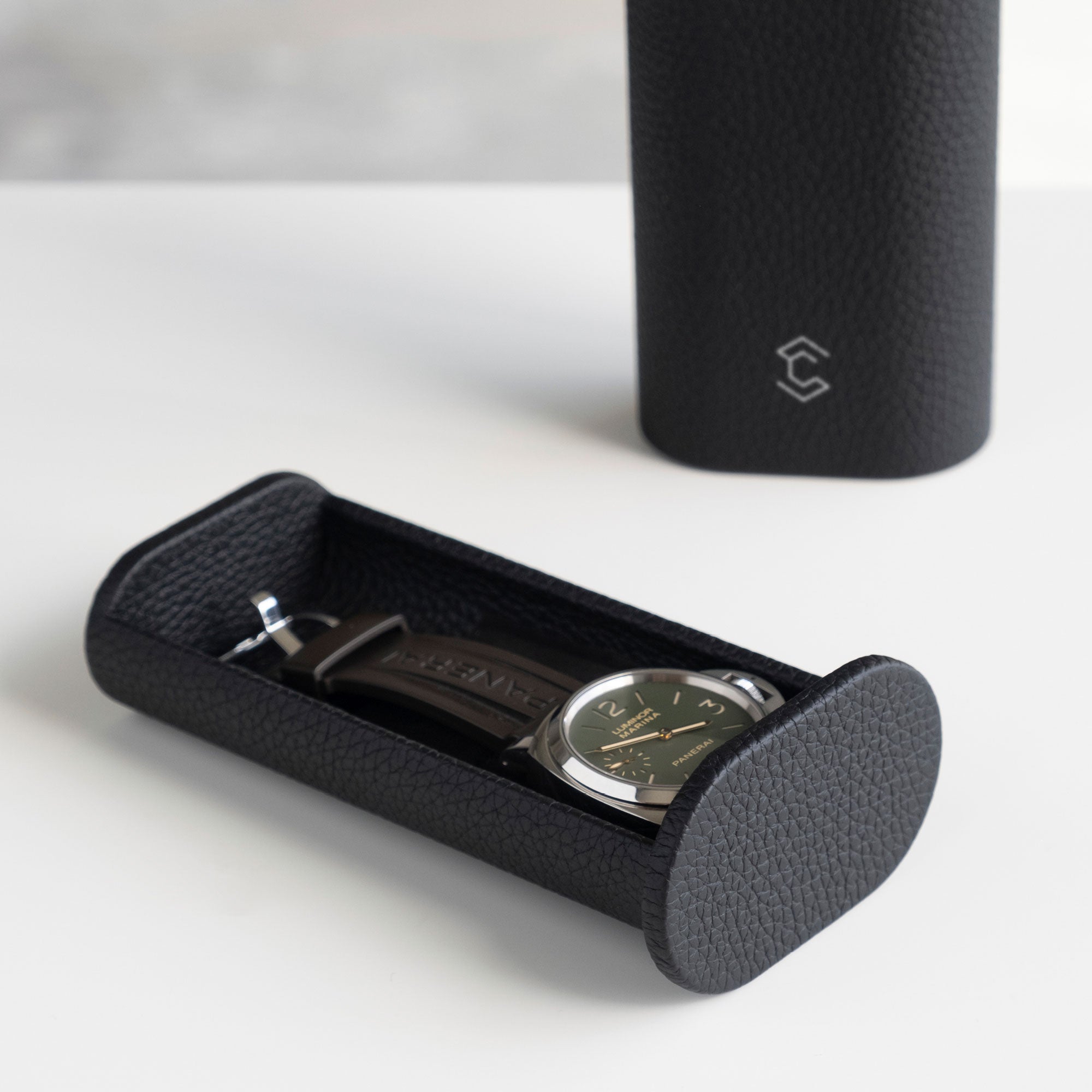 Watch with rubber strap placed in black leather Oscar 1 Tall Travel Watch roll. Handmade in Canada.