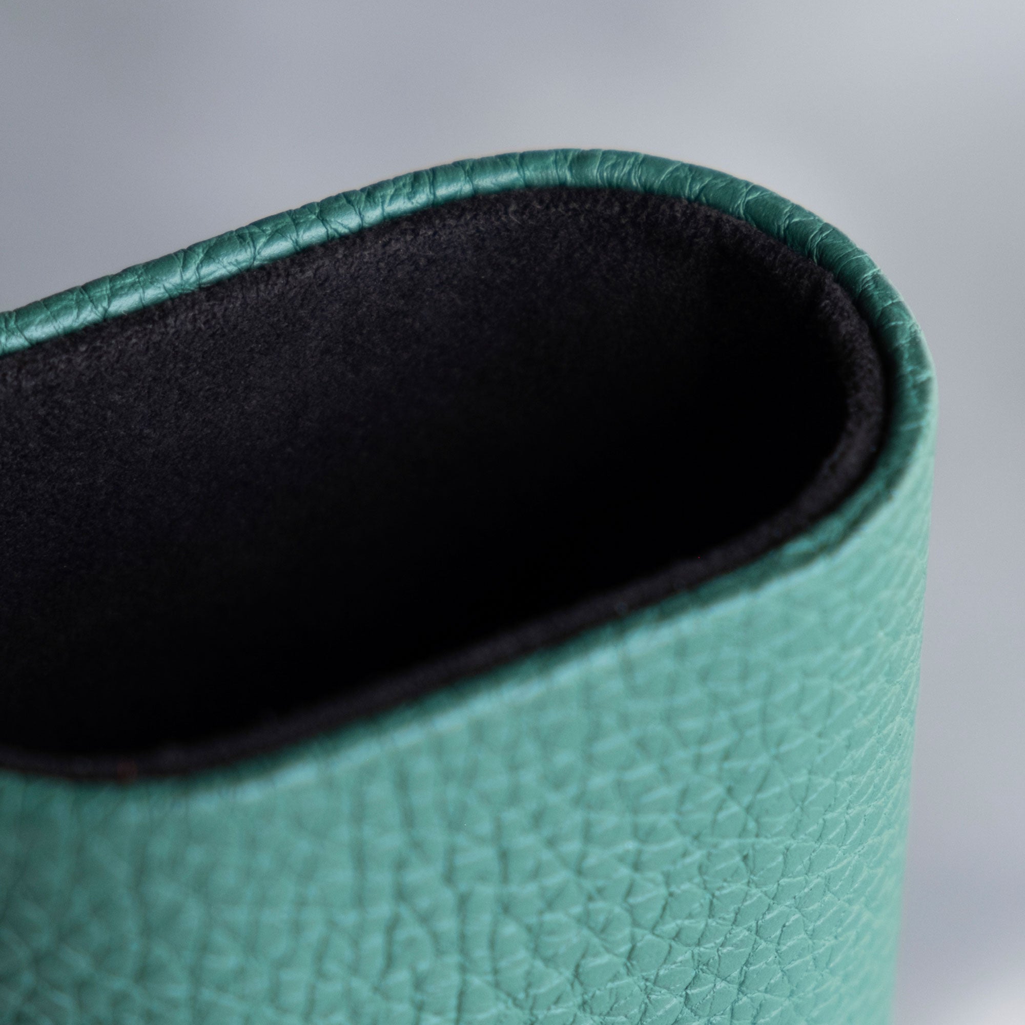 Detail photo of emerald french leather and black Alcantara interior lining of the Charles Simon Oscar Travel Watch roll.