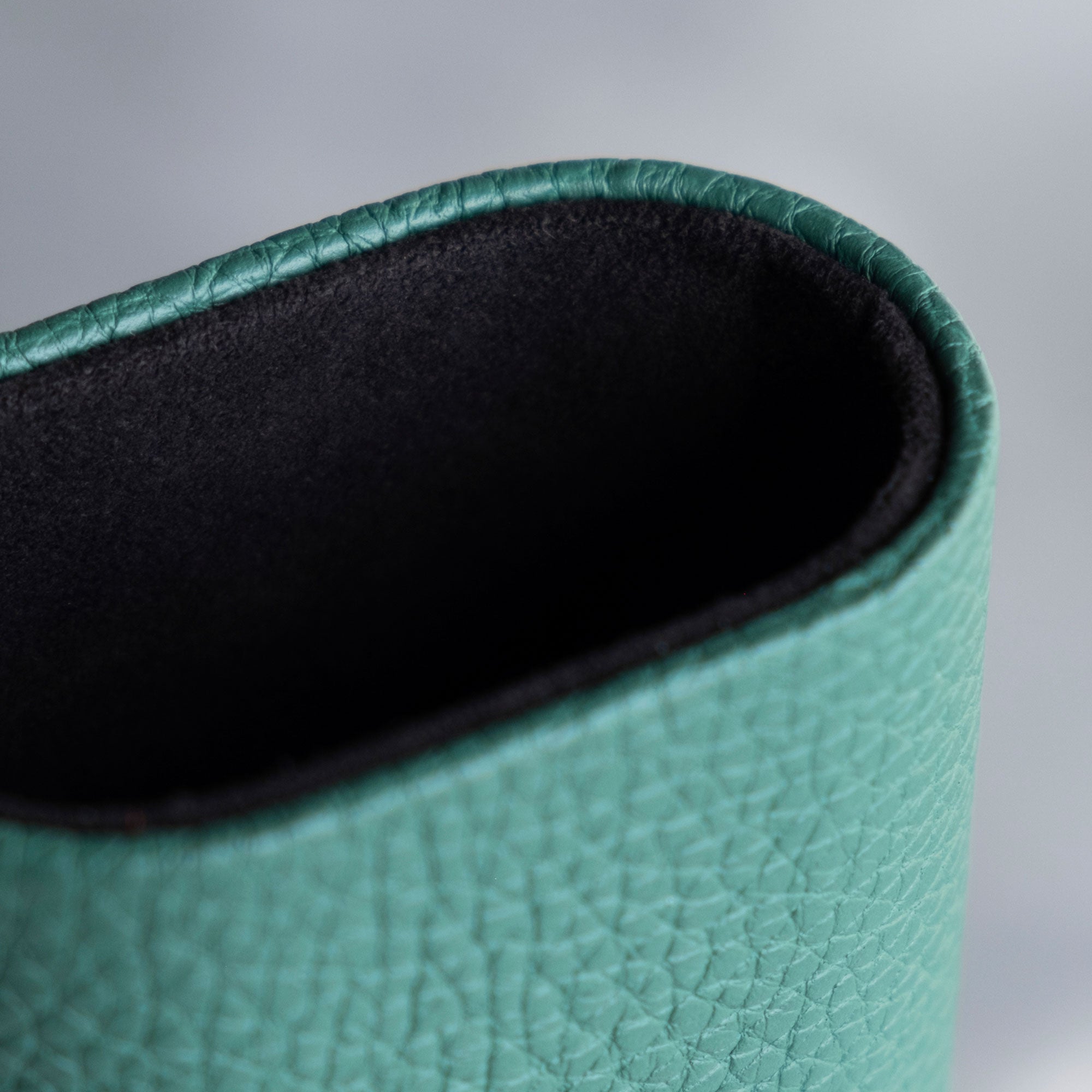 Detail photo of emerald french leather and black Alcantara interior lining of the Charles Simon Oscar Watch roll.