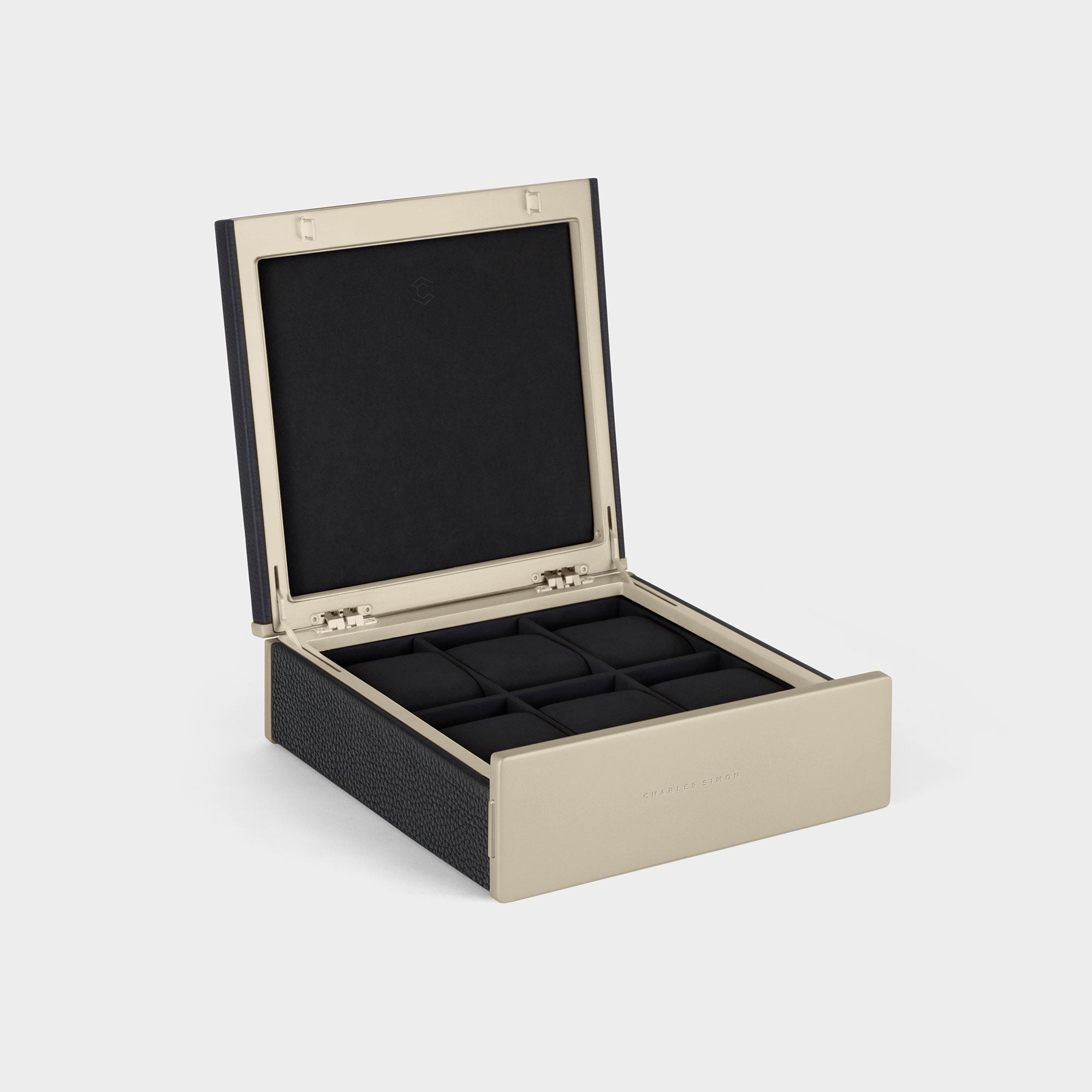 Product photo of open Spence 6 Watch box featuring gold accents, black leather and removable watch cushions for up to 6 watches