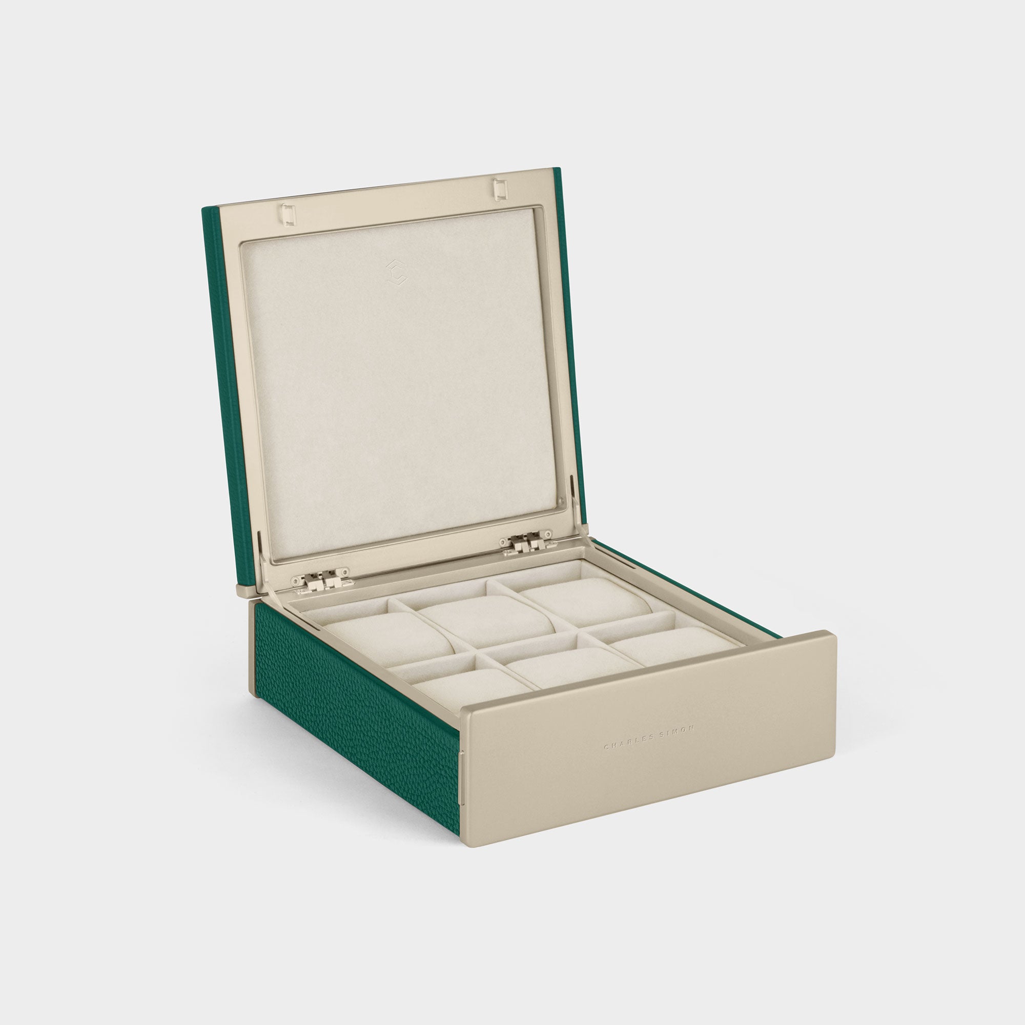 Product photo of open Spence 6 Watch box featuring gold accents, emerald leather and eggshell removable watch cushions for up to 6 watches