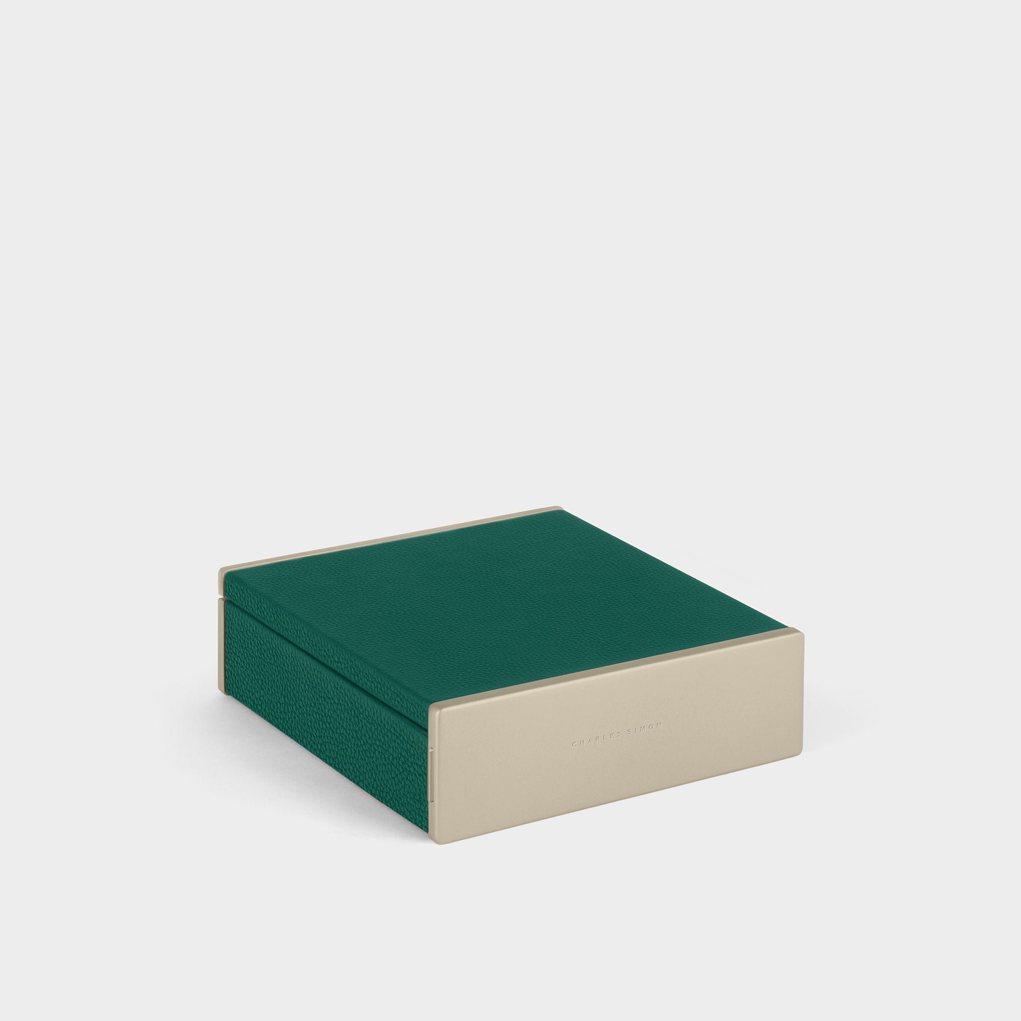 Product photo of closed gold watch box with emerald leather. Handmade in Canada.