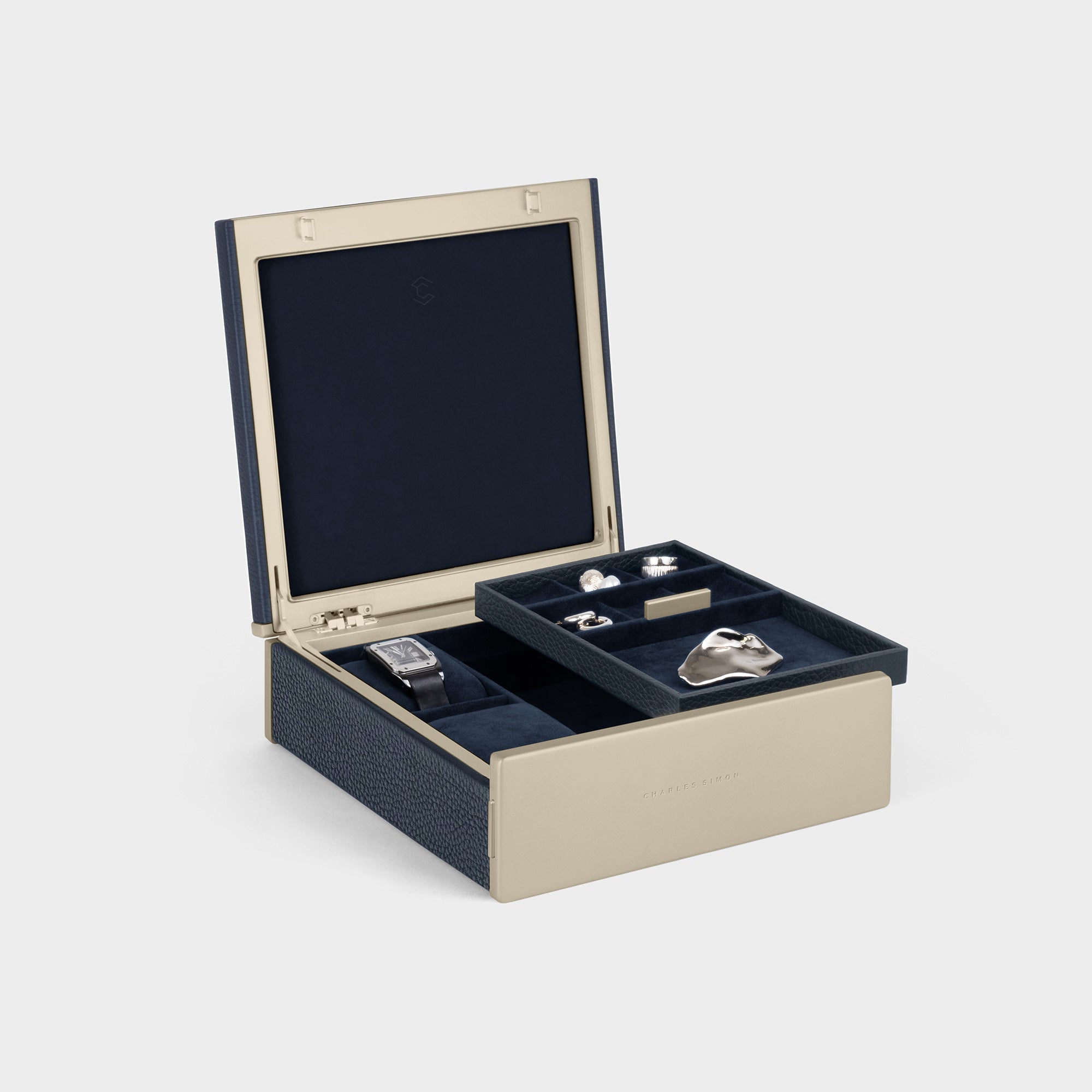Charles Simon Taylor 2 Watch and Jewelry box in gold anodized aluminum and carbon fiber framing and marine leather. The watch and jewelry box features a removable jewelry tray for conveniently organizing and storing your rings, bracelets, necklaces, rings and more