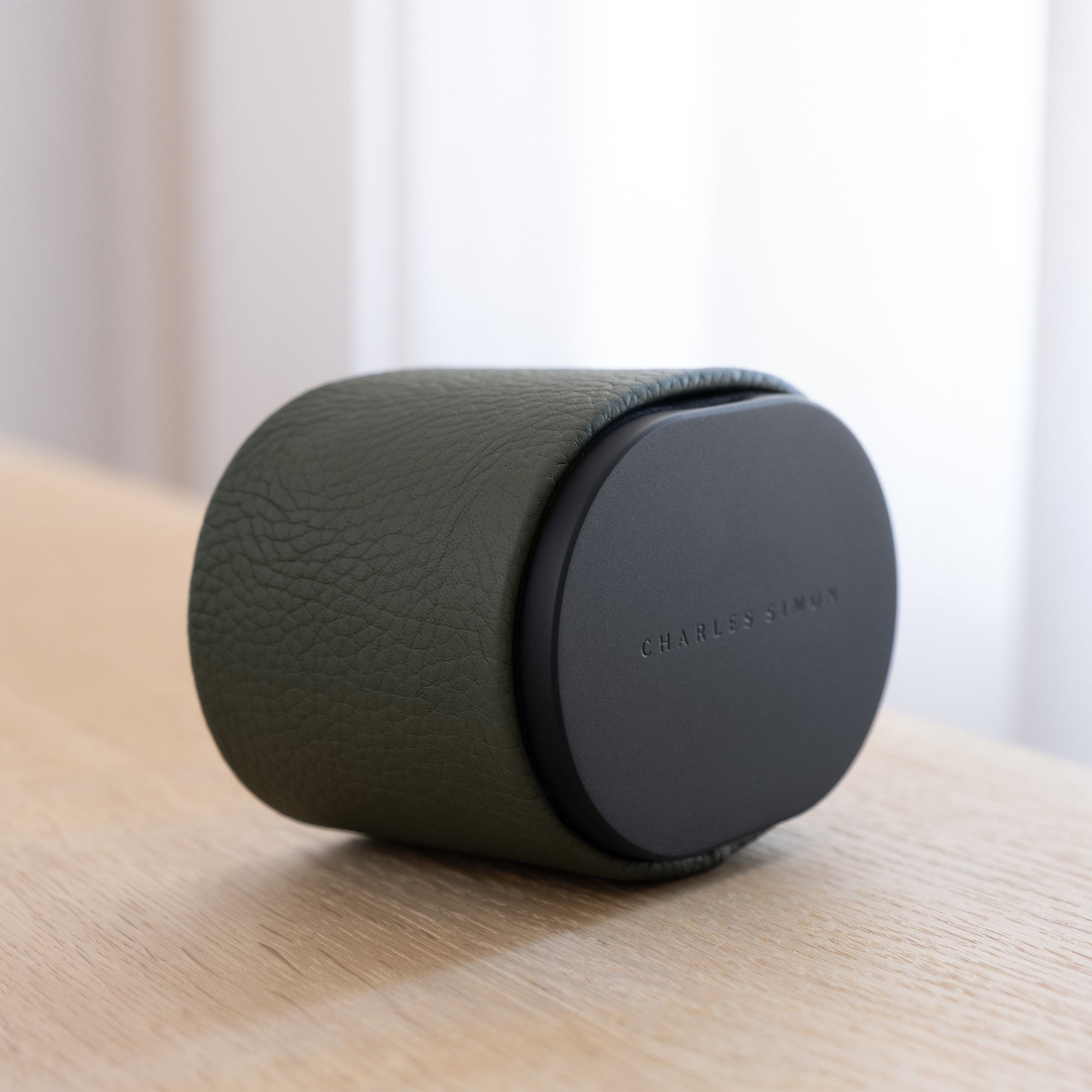 Lifestyle shot of closed designer leather watch roll by Charles Simon. Handmade in Canada from khaki leather and black anodized aluminum.