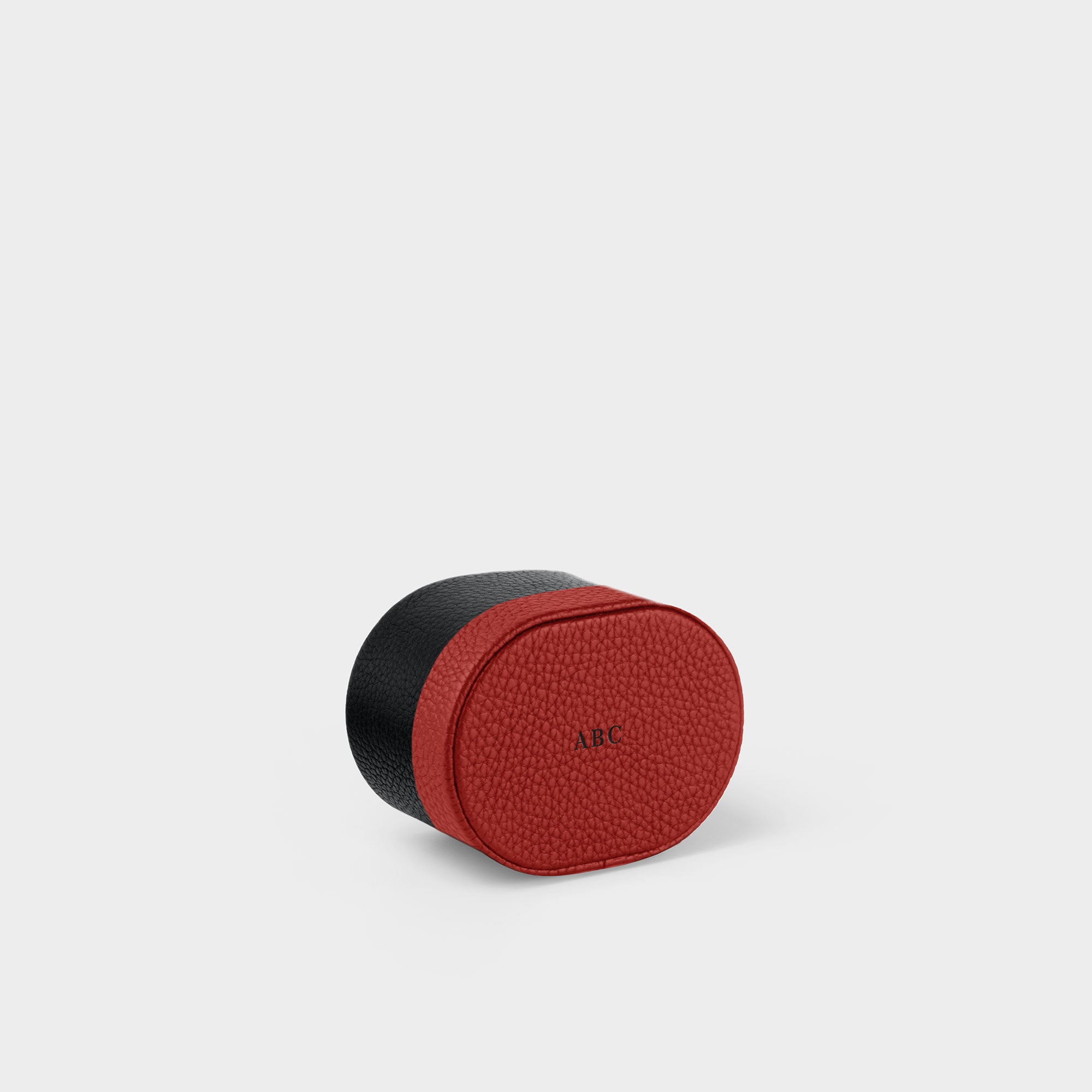 Personalized initials hot stamped on the bottom of the red leather watch roll by Charles Simon. 