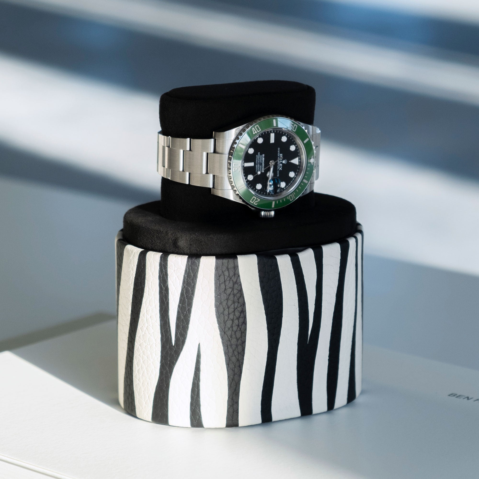 Luxury watch displayed on elegant zebra watch roll by Charles Simon in convenient portable watch stand position