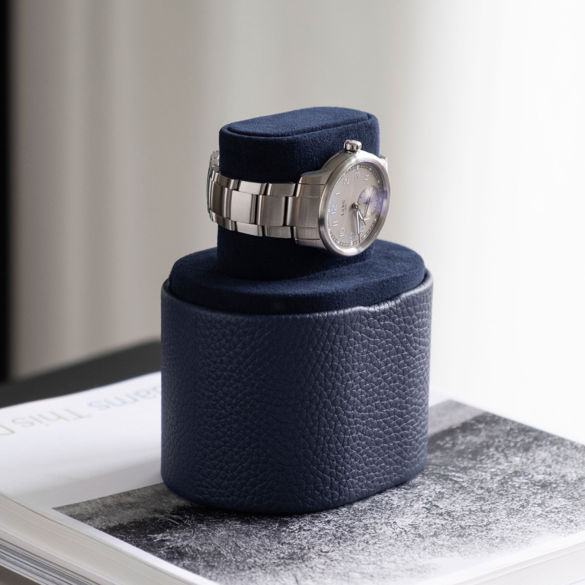 Men's watch displayed on Theo Watch roll in watch stand position. Handmade in Canada from young bull leather and grey anodized aluminum.