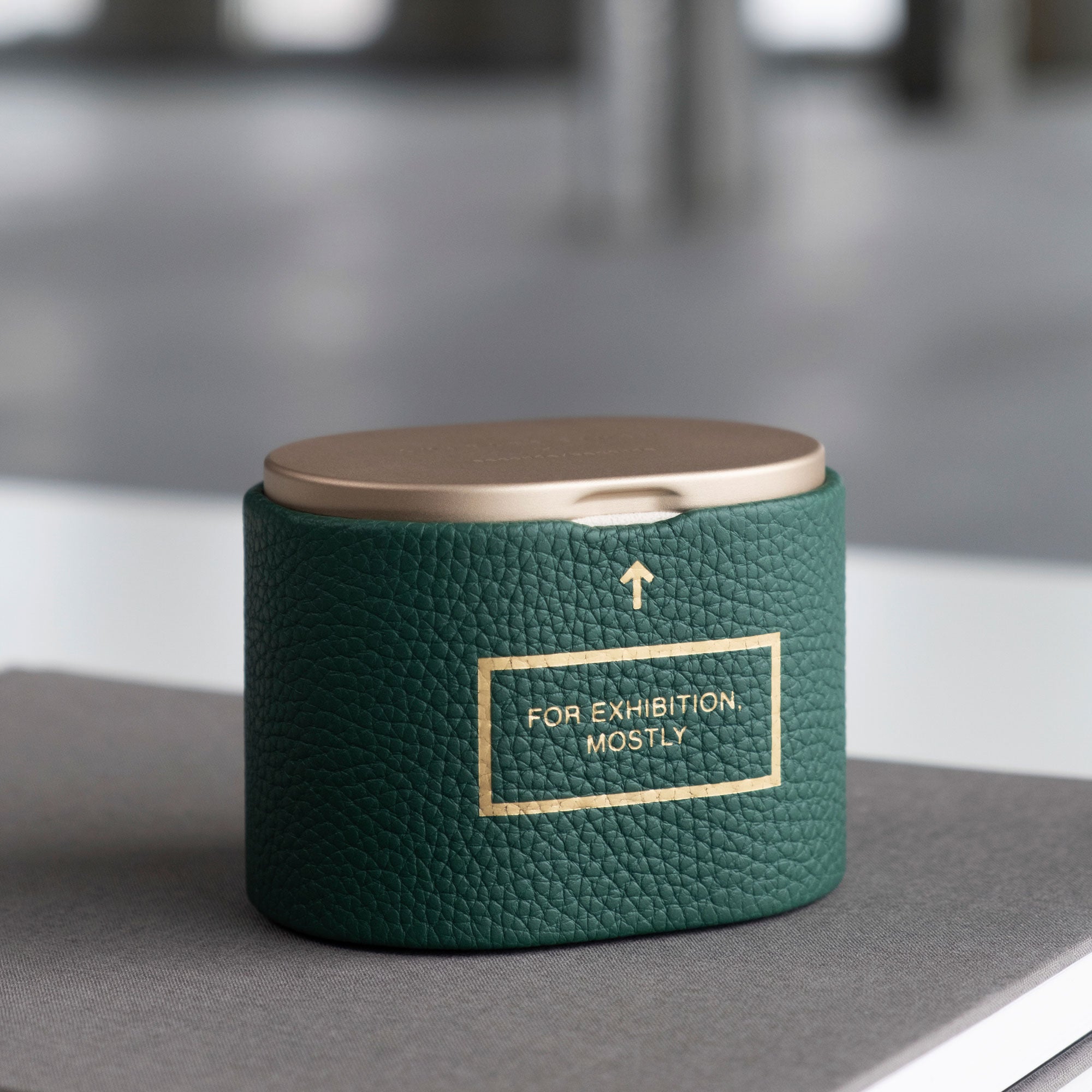 Charles Simon x seconde/ seconde/ limited edition watch roll for one watch. A tongue-in-cheek homage to Rolex's exhibition only watches. Handmade from emerald leather and champagne anodized aluminum