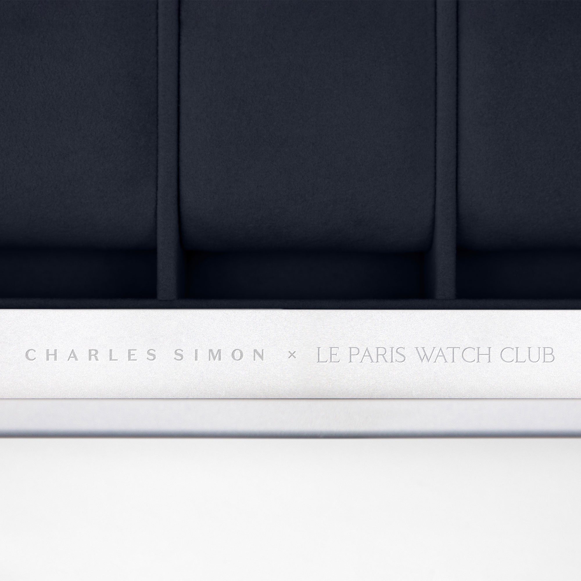 Detail photo showing Charles Simon x Paris Watch Club engraving on the casing of the Mackenzie 12 Watch briefcase