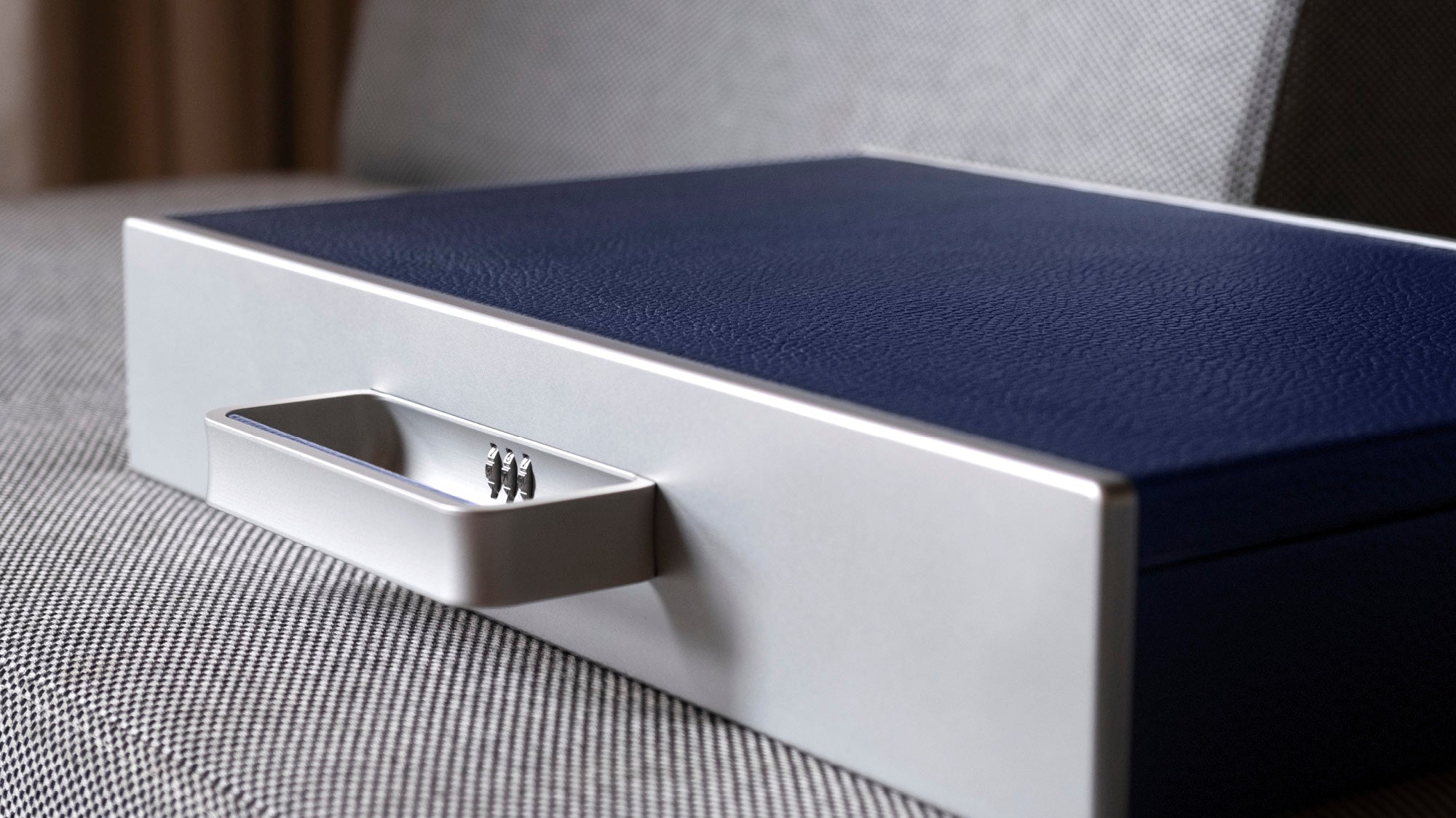 Detail photo of Mackenzie Briefcase in grey carbon fiber and anodized aluminum and sapphire leather