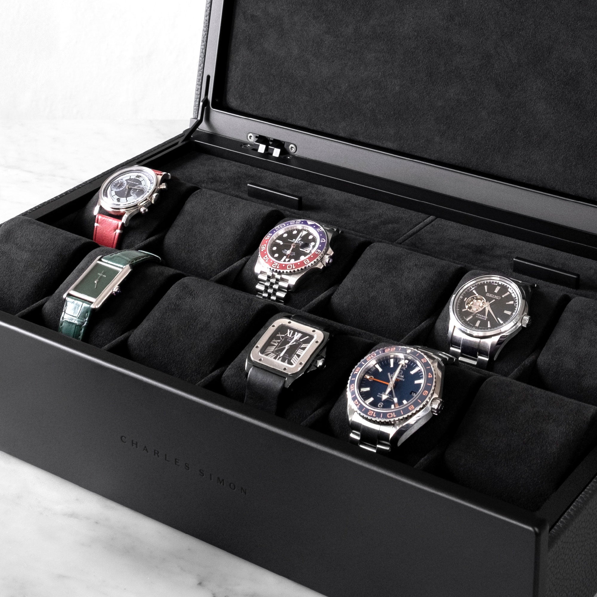 Lifestyle shot of luxury watch collection displayed in all black Spence 12 Watch box for up to 12 watches 