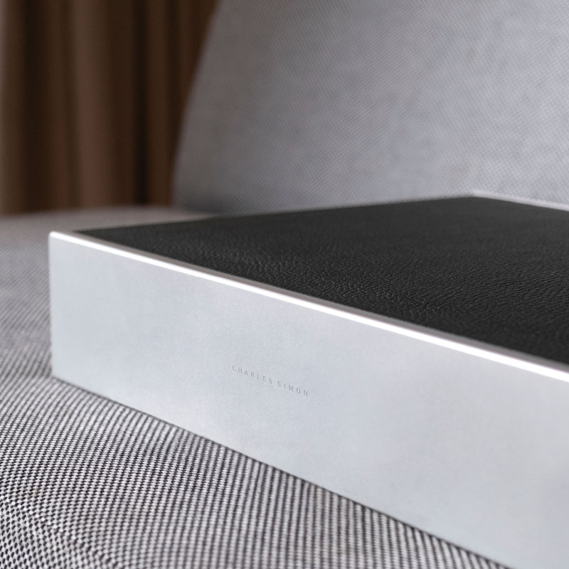 Closed Spence 6 Watch box in black leather and carbon fiber and anodized aluminum frame with engraved Charles Simon logo