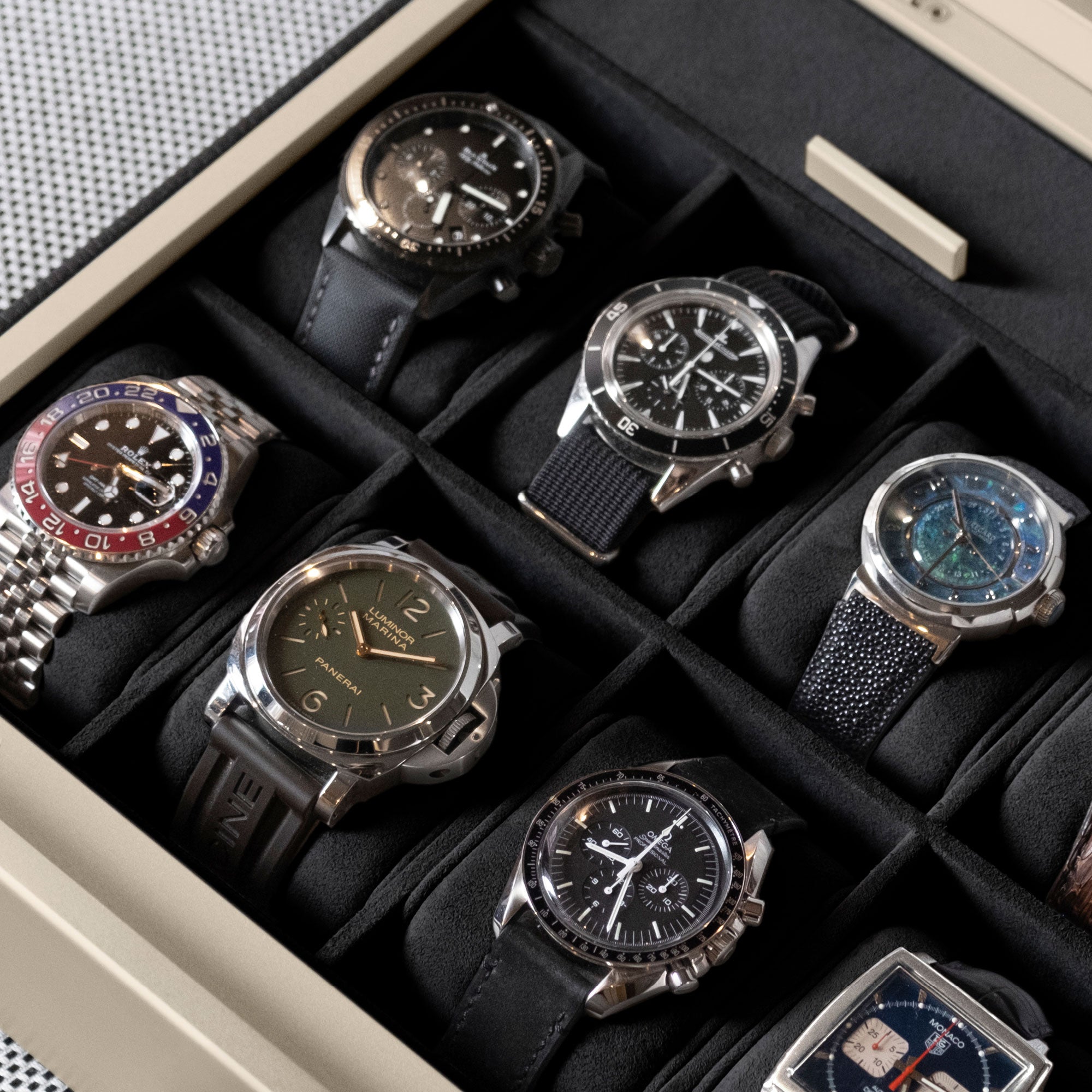 Detail photo of luxury watches displayed in the Spence 12 Watch box in black leather and gold aluminum