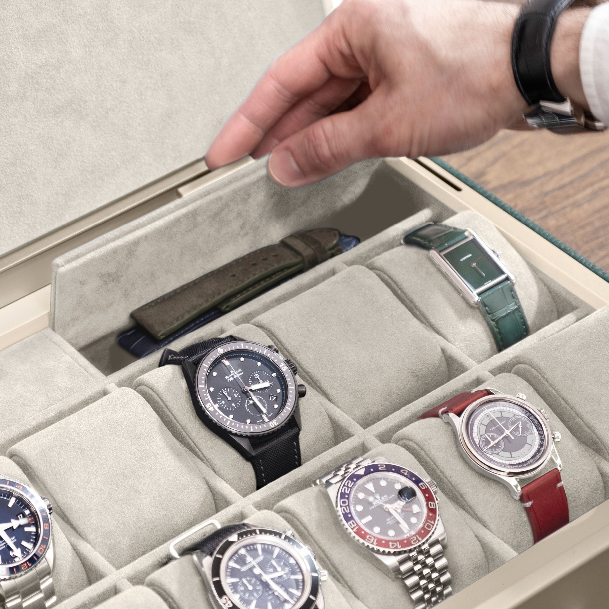 Man opening additional storage compartment of his Spence 12 Watch box holding his collection of luxury watches