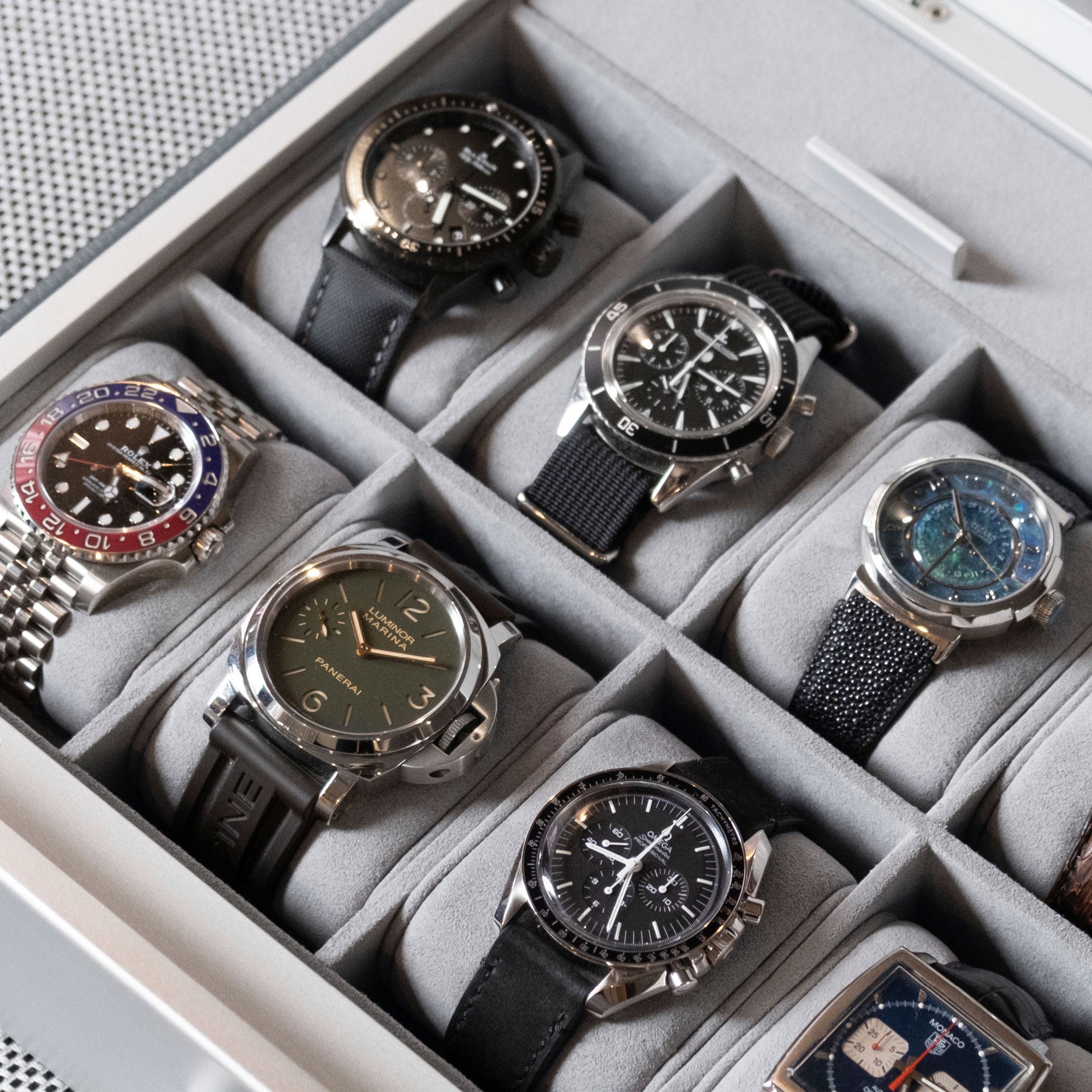 Detail photo of luxury watch collection displayed in Spence 12 Watch box in cloud grey leather and fog grey Alcantara