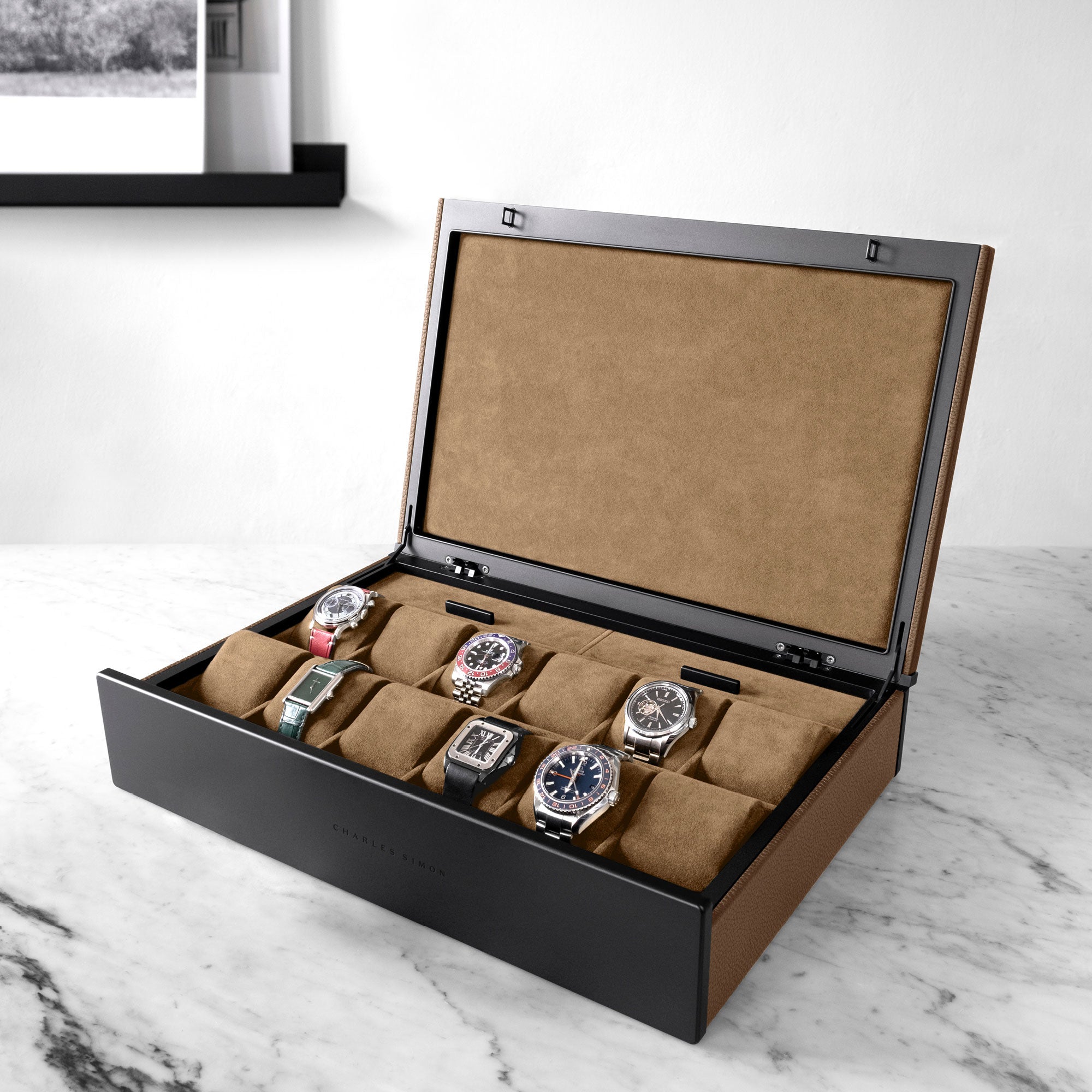 Lifestyle photo of man opening tan leather Spence 12 Watch box with luxury watch collection displayed inside