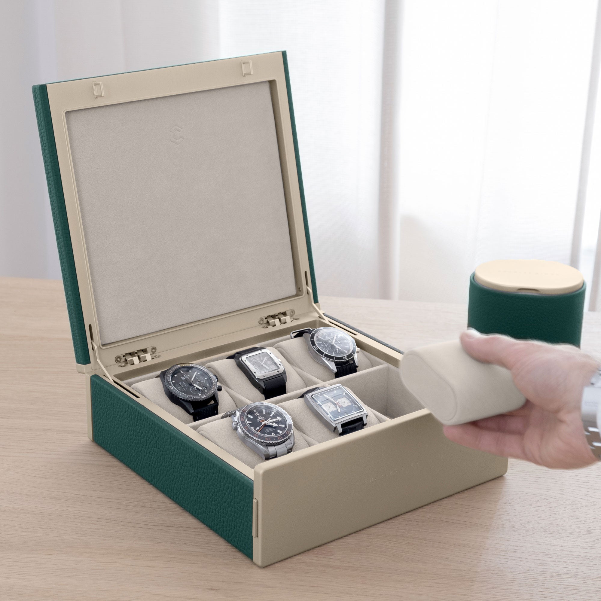 Man holding soft watch cushion from his gold watch box for his watch collection of up to 6 timepieces. 