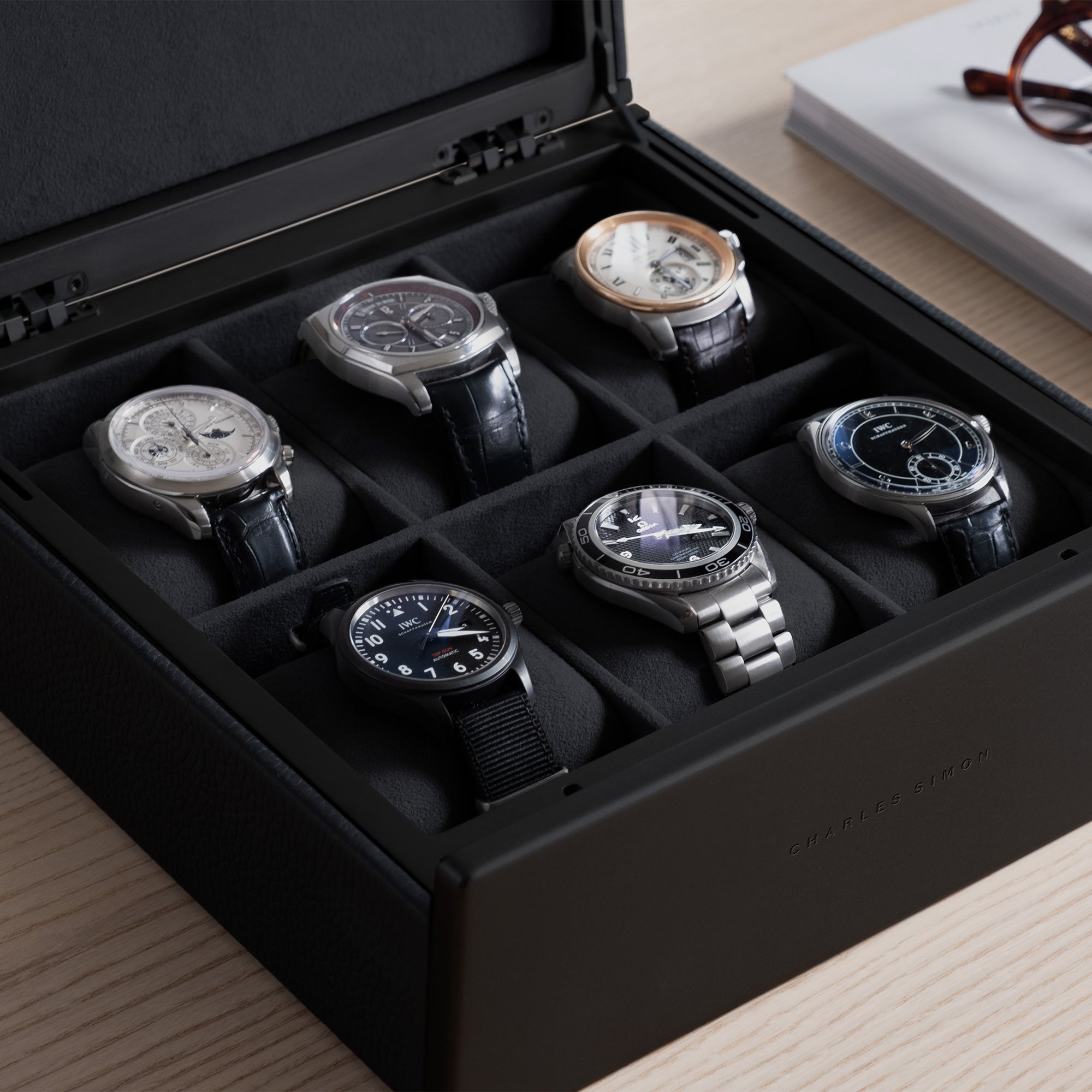 Detail shot of six luxury watches displayed in the all black Spence 6 watch box