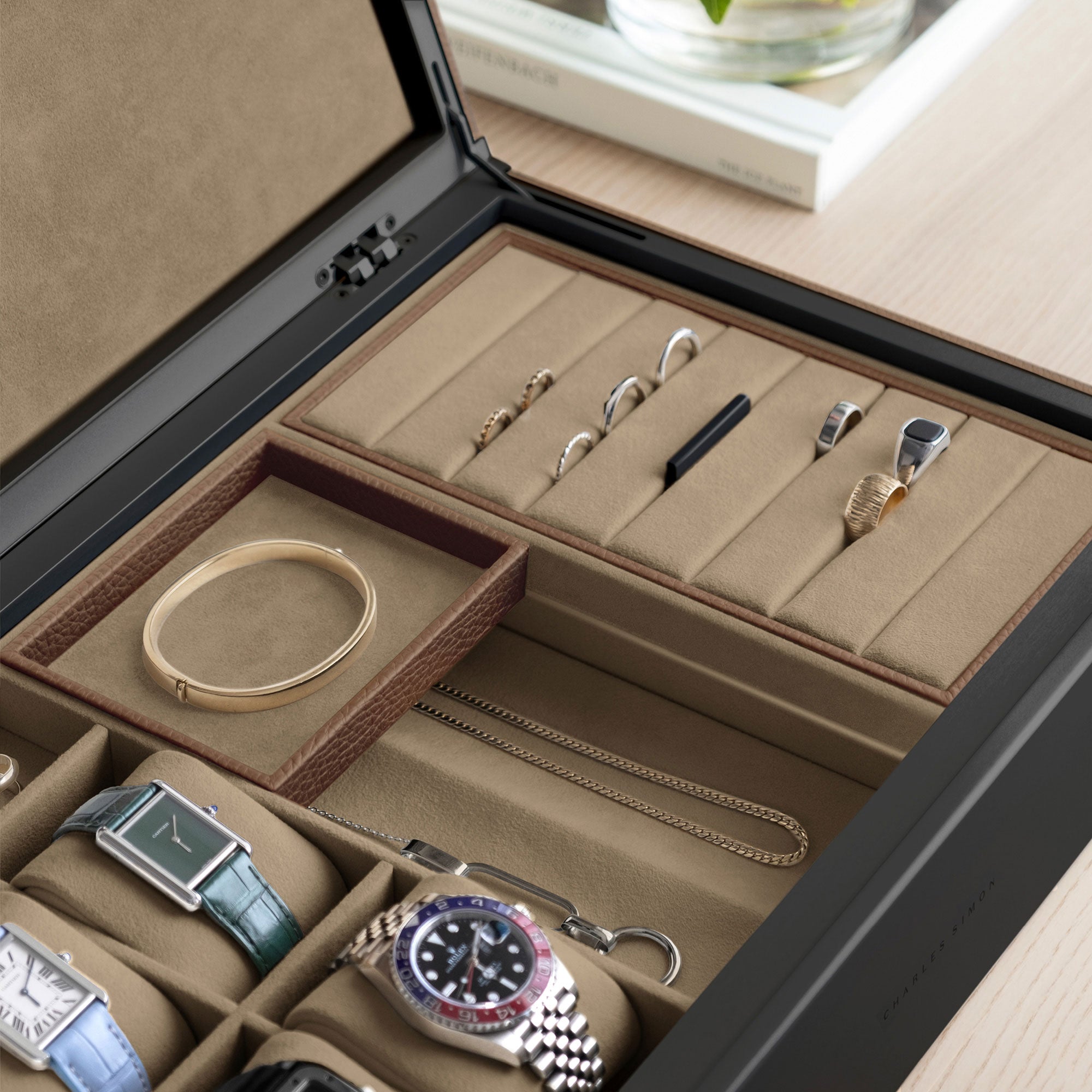 Detail photo of jewelry storage compartments and watch cushions of the Taylor 4 Watch and Jewelry box in tan leather and camel interior.