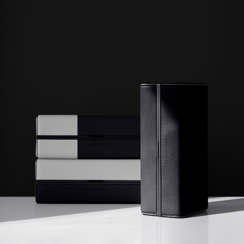 Lifestyle shot of limited edition Light & Shadow Moraine toiletry bags made from fine French leather and black anodized aluminum