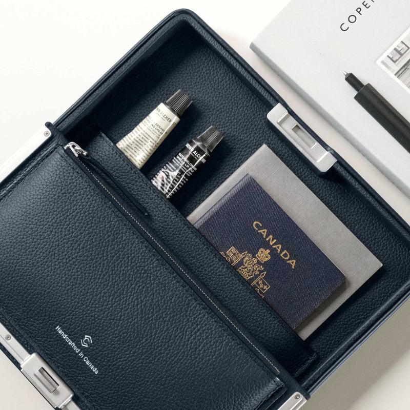 Lifestyle photo of Fraser travel wallet holding travel essentials including passport, notebook, beauty creams