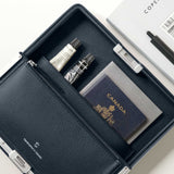 Lifestyle shot of open Fraser travel wallet holding passport, notebook and other everyday essentials