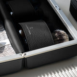 Detail shot of makeup brush in luxury toiletry bag by Charles Simon