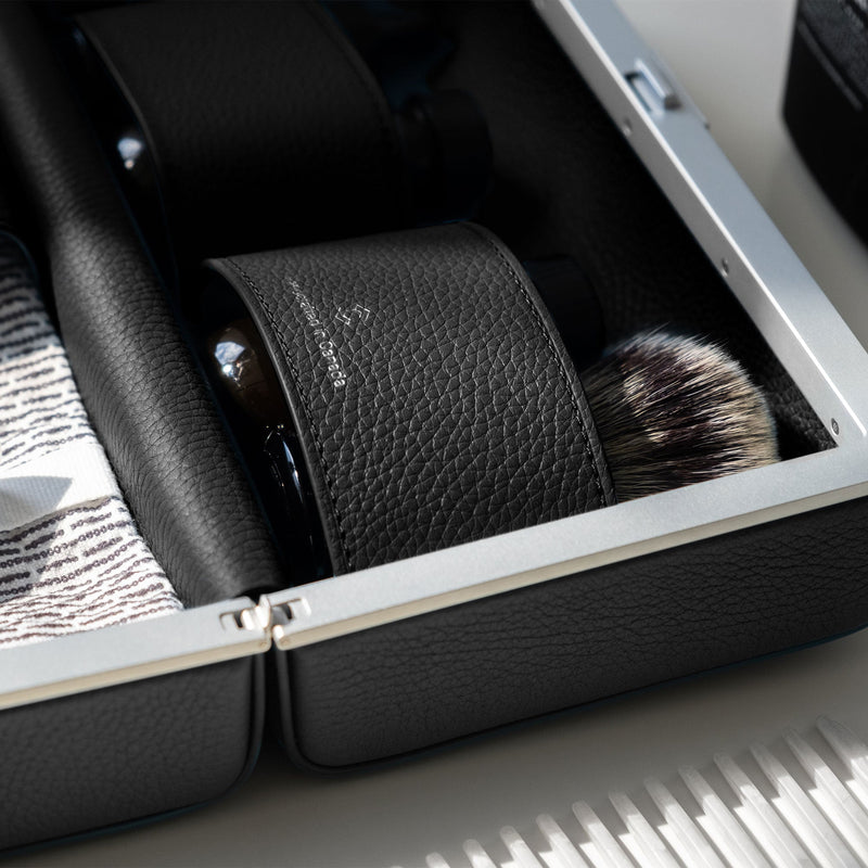 Detail shot of makeup brush in luxury toiletry bag by Charles Simon 