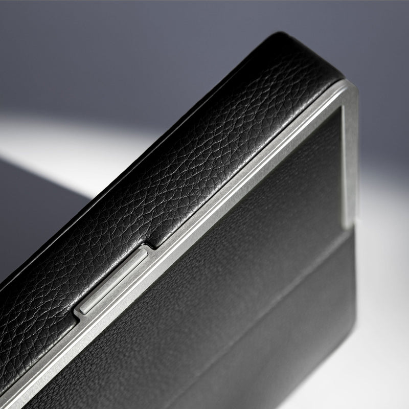 Detail shot of premium leather and carbon fiber and anodized aluminum frame of the Fraser travel wallet